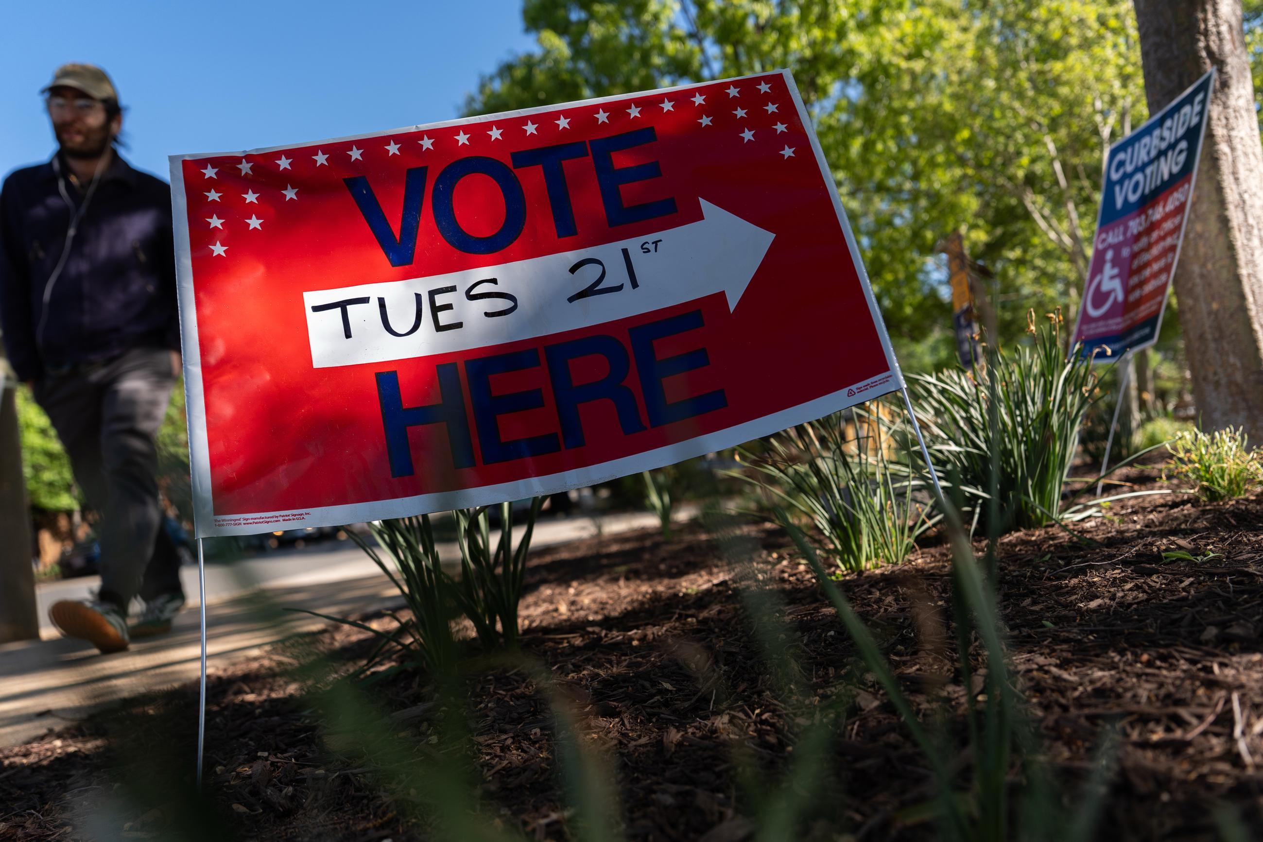 A person walks to vote in the Virginia redistricting referendum at Lyles-Crouch Traditional Academy, Tuesday, April 21, 2026, in Alexandria, Va. (AP Photo/Julia Demaree Nikhinson)