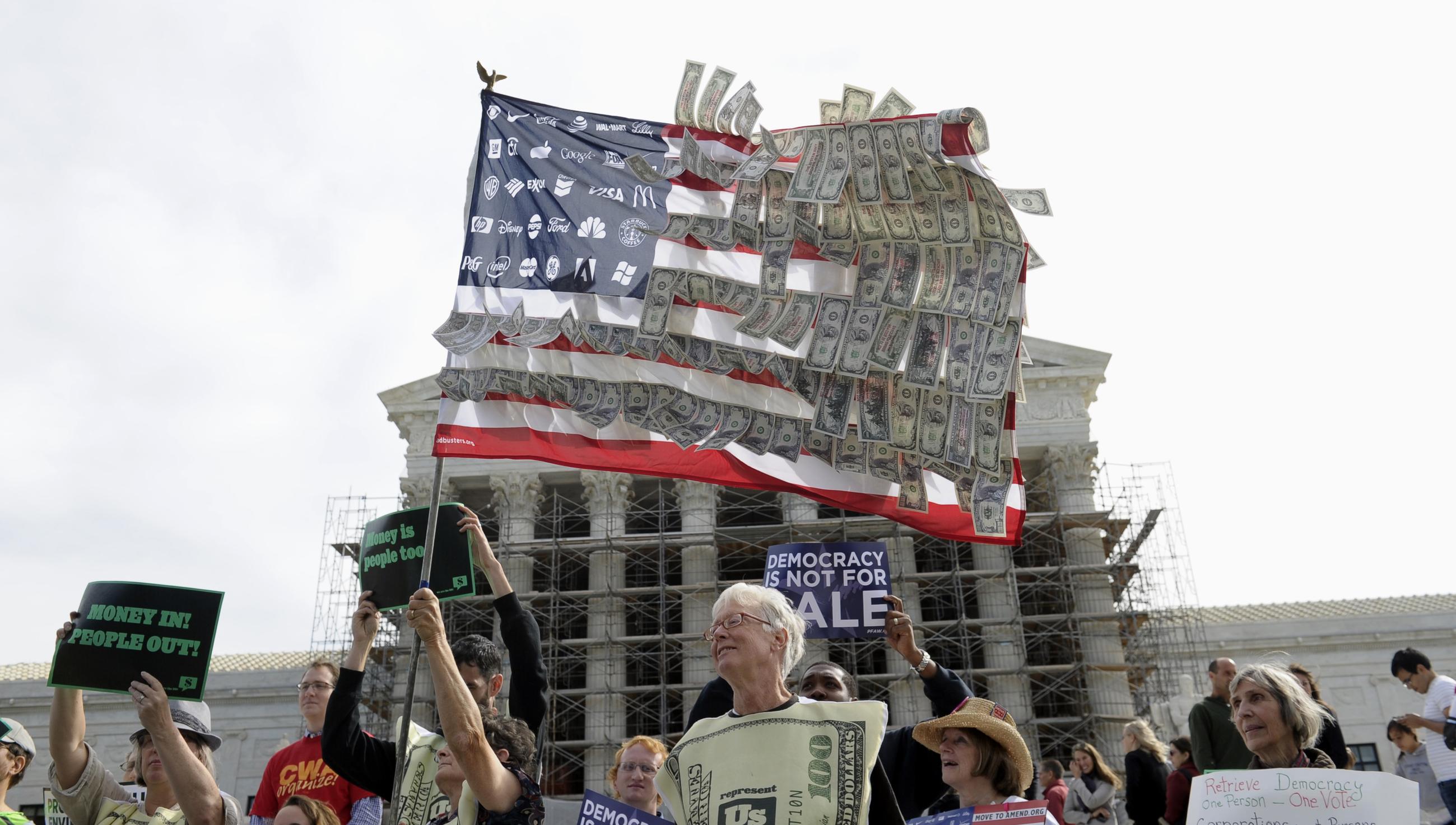 Demonstrators gather outside the Supreme Court in Washington, Tuesday, Oct. 8, 2013, as the court heard arguments on campaign finance. The Supreme Court is tackling a challenge to limits on contributions by the biggest individual donors to political campaigns. The case being argued at the high court Tuesday is a test of the Roberts court's readiness to take its most aggressive swipe at campaign finance laws since its Citizens United decision in 2010 took the lid off independent spending by corporations and labor unions. (AP Photo/Susan Walsh)