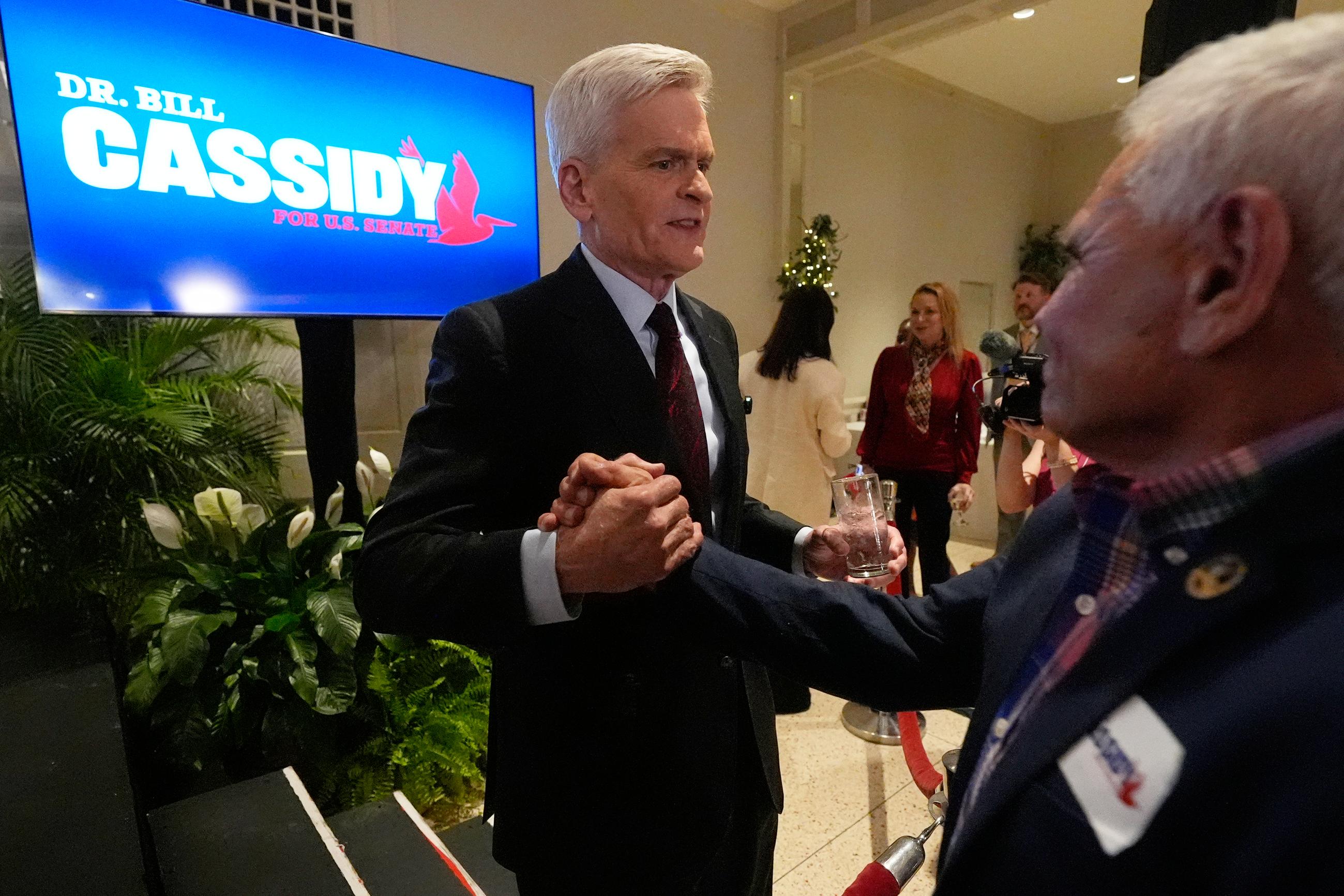 Sen. Bill Cassidy, R-La., left, greets supporters after speaking during an election night watch party Saturday, May 16, 2026, in Baton Rouge, La. (AP Photo/Gerald Herbert)