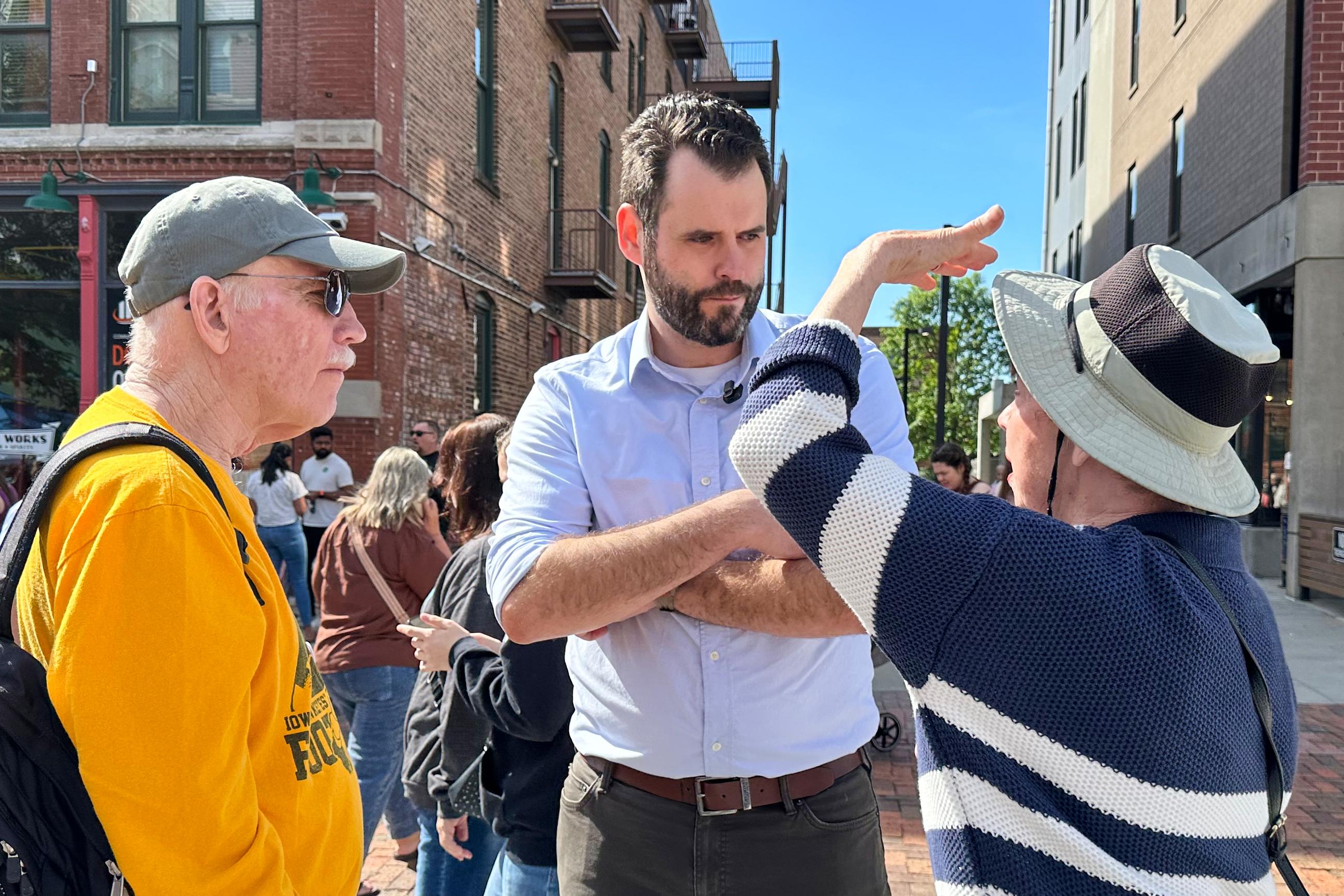 Iowa state Sen. Zach Wahls, a Democratic candidate for U.S. Senate, talks with voters in Des Moines, Iowa, Saturday, May 23, 2026. (AP Photo/Hannah Fingerhut)