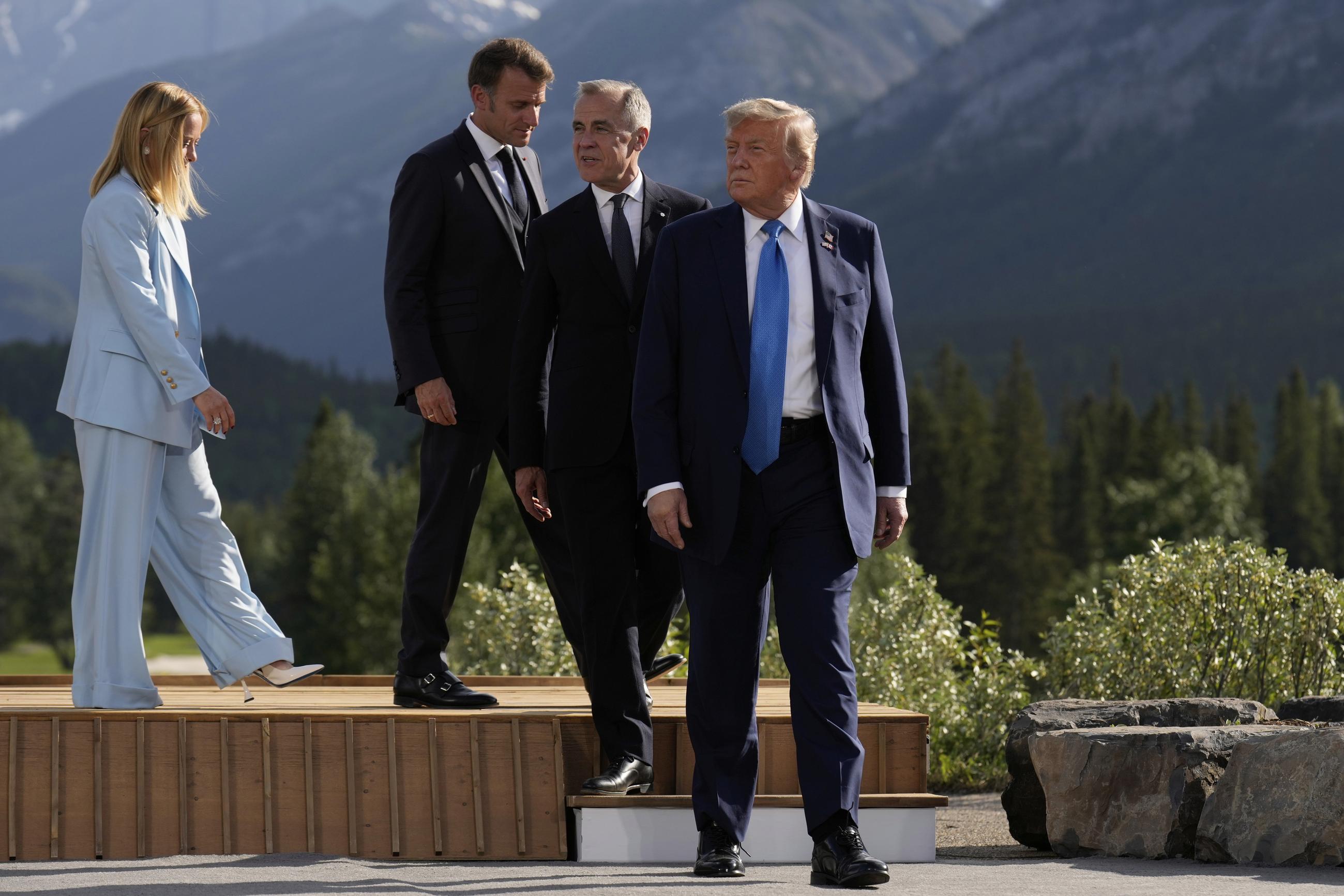 President Trump, followed by Canadian Prime Minister Mark Carney, French President Emmanuel Macron, and Italian Prime Minister Giorgia Meloni, walk from the podium after a group photo at the G-7 Summit in Kananaskis, Canada, in June 2025. (AP Photo/Mark Schiefelbein)