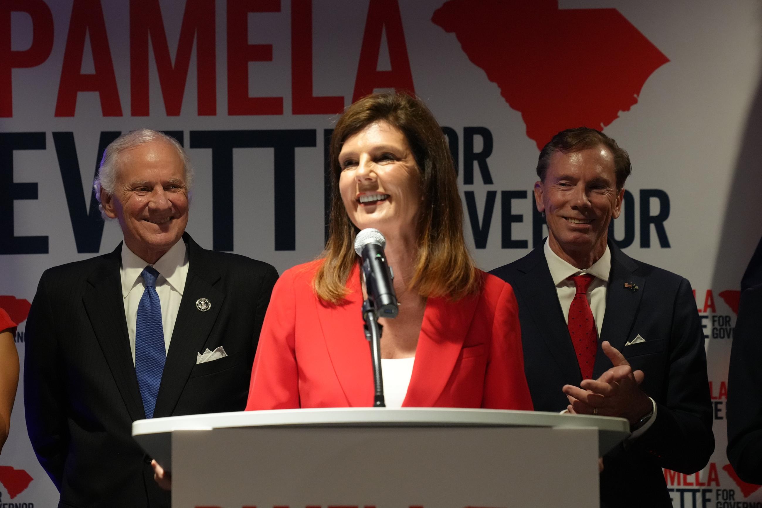 South Carolina Lt. Gov. Pamela Evette, flanked by Gov. Henry McMaster and her husband, David Evette, speaks at an election night watch party after advancing to a GOP primary runoff in the governor's race on June 9 in Greenville, S.C. (AP Photo/Meg Kinnard)