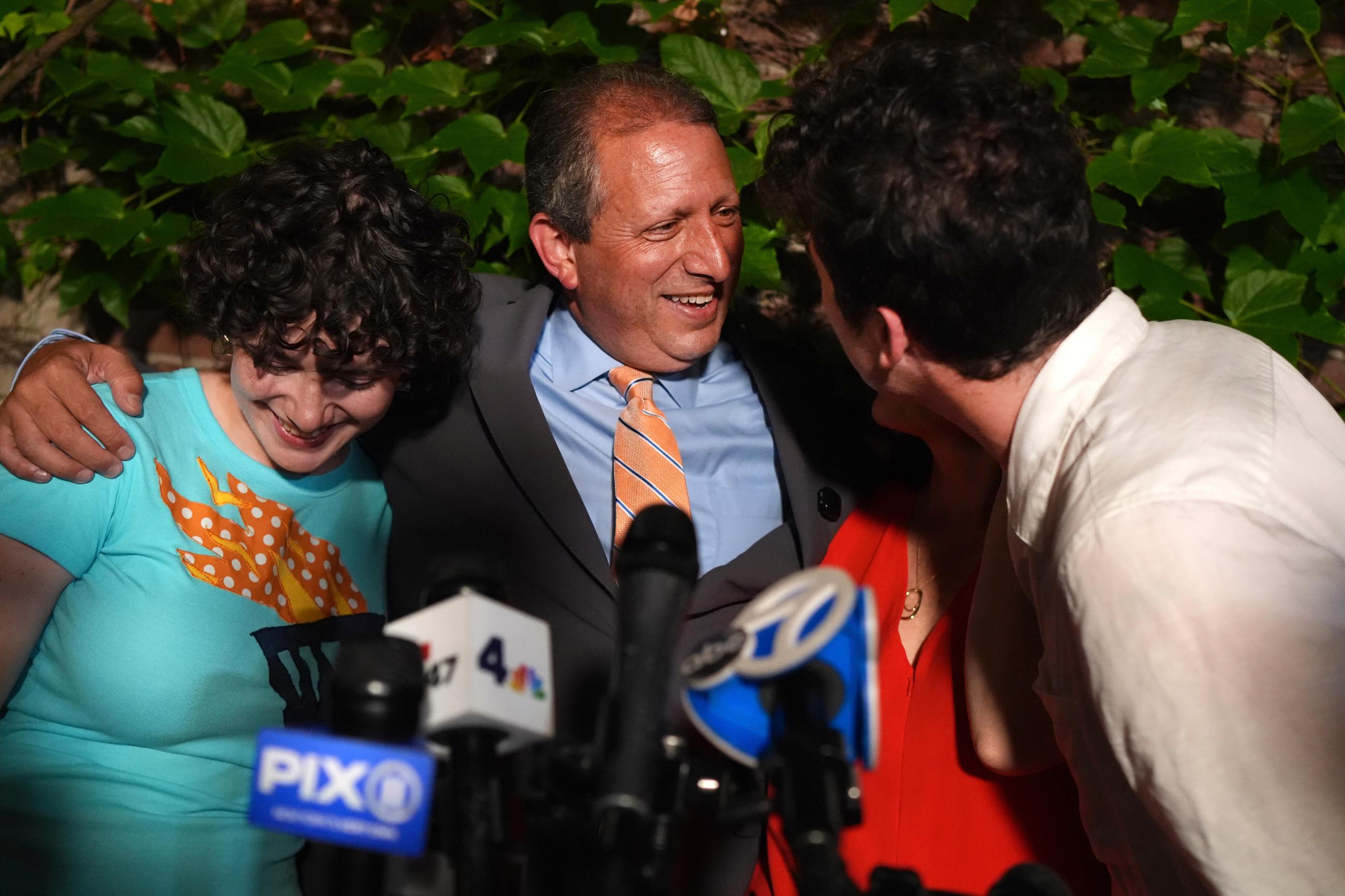 Democratic congressional candidate Brad Lander is hugged by his family during an election night watch party Tuesday, June 23, 2026, in New York. (AP Photo/Ryan Murphy)