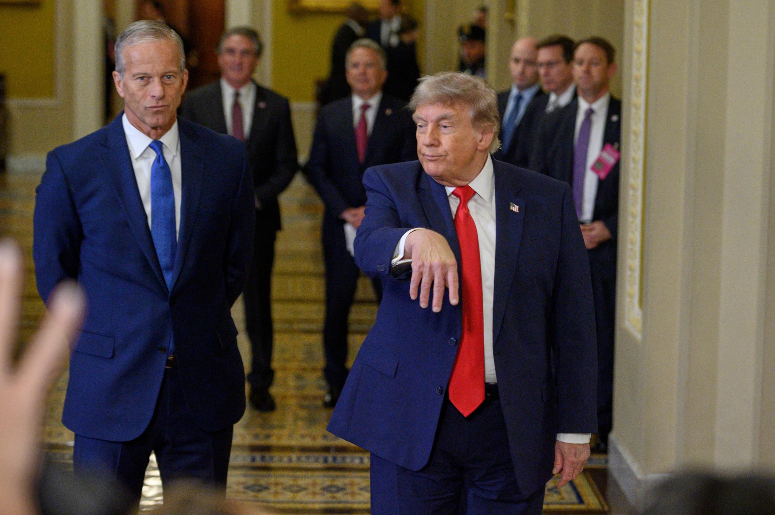 President Trump, escorted by Senate Majority Leader John Thune,heads to a meeting with Senate Republicans on Wednesday. (AP Photo/Cliff Owen)