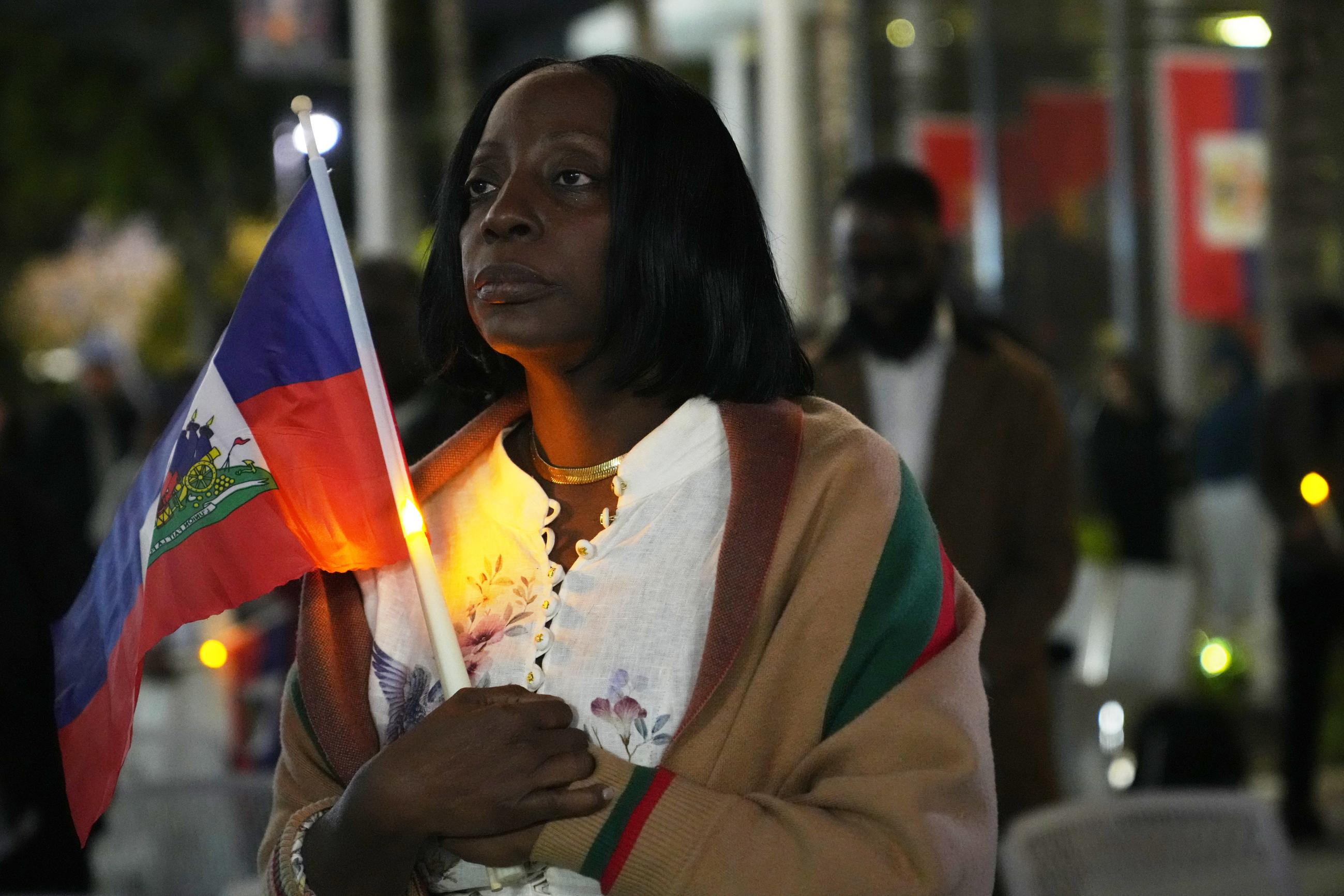 Linda Joseph holds a candle during a vigil at the Little Haiti Cultural Complex in North Miami after a federal judge blocked the Trump administration from ending temporary immigration status for Haitians on Feb. 3. (AP Photo/Lynne Sladky, File)