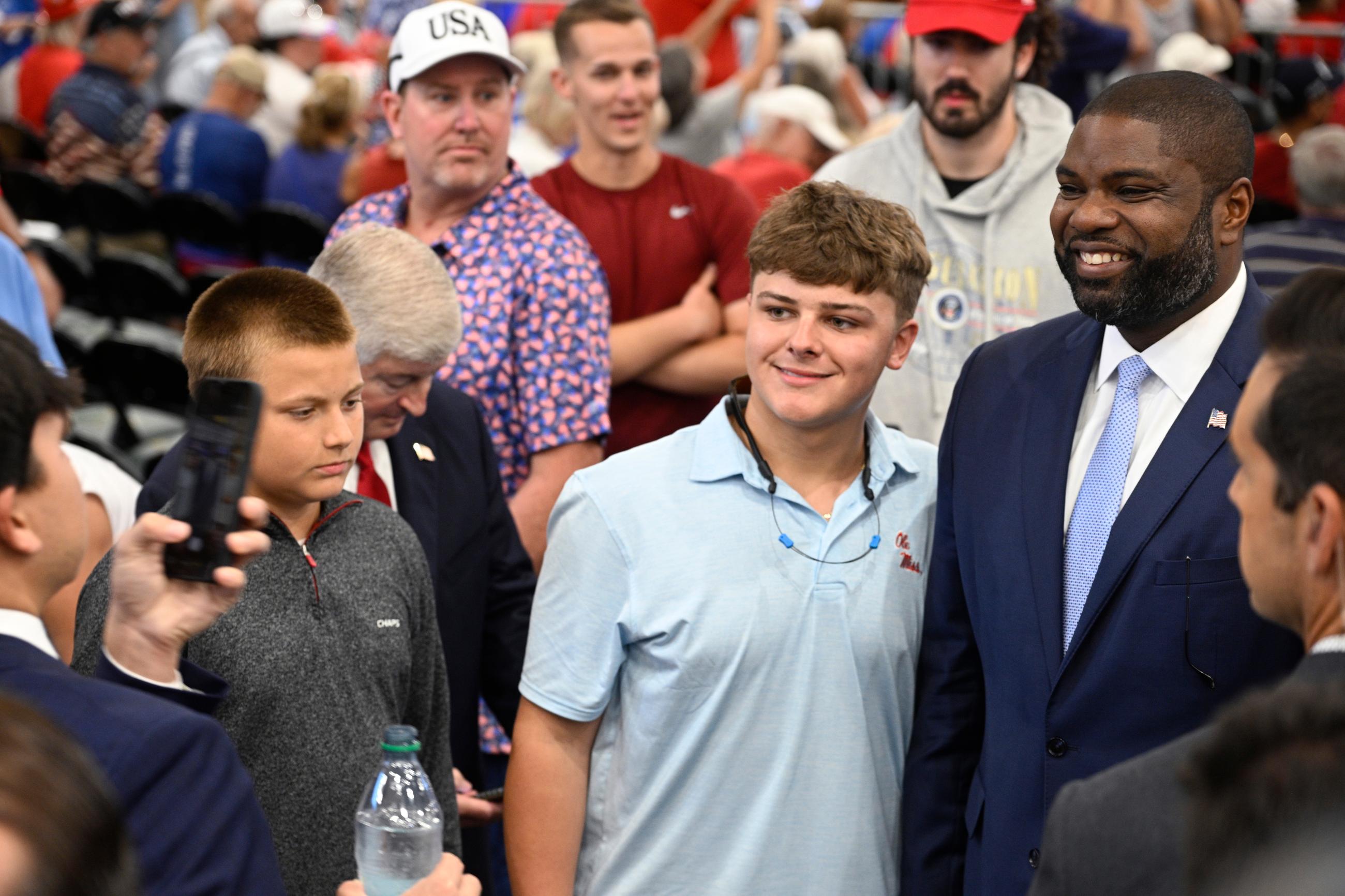 Rep. Byron Donalds, R-Fla., right, poses with attendees before President Donald Trump speaks, Friday, May 1, 2026, in The Villages, Fla. (AP Photo/Phelan M. Ebenhack)