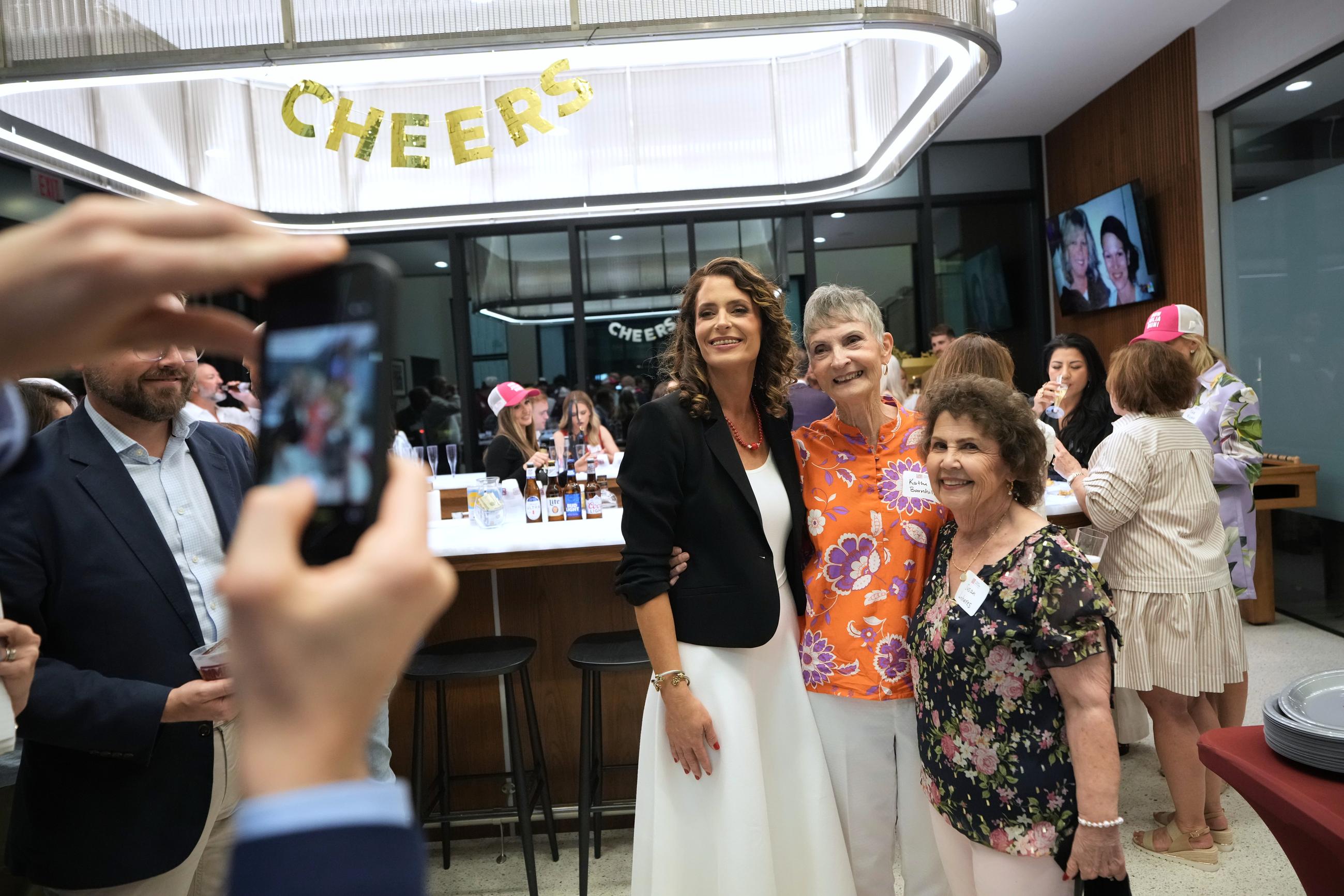 U.S. Senate candidate Rep. Julia Letlow, R-La., center left, poses for a photo with her mother, Kathi Barnhill, center, after speaking during an election night watch party Saturday, May 16, 2026, in Baton Rouge, La. (AP Photo/Matthew Hinton)