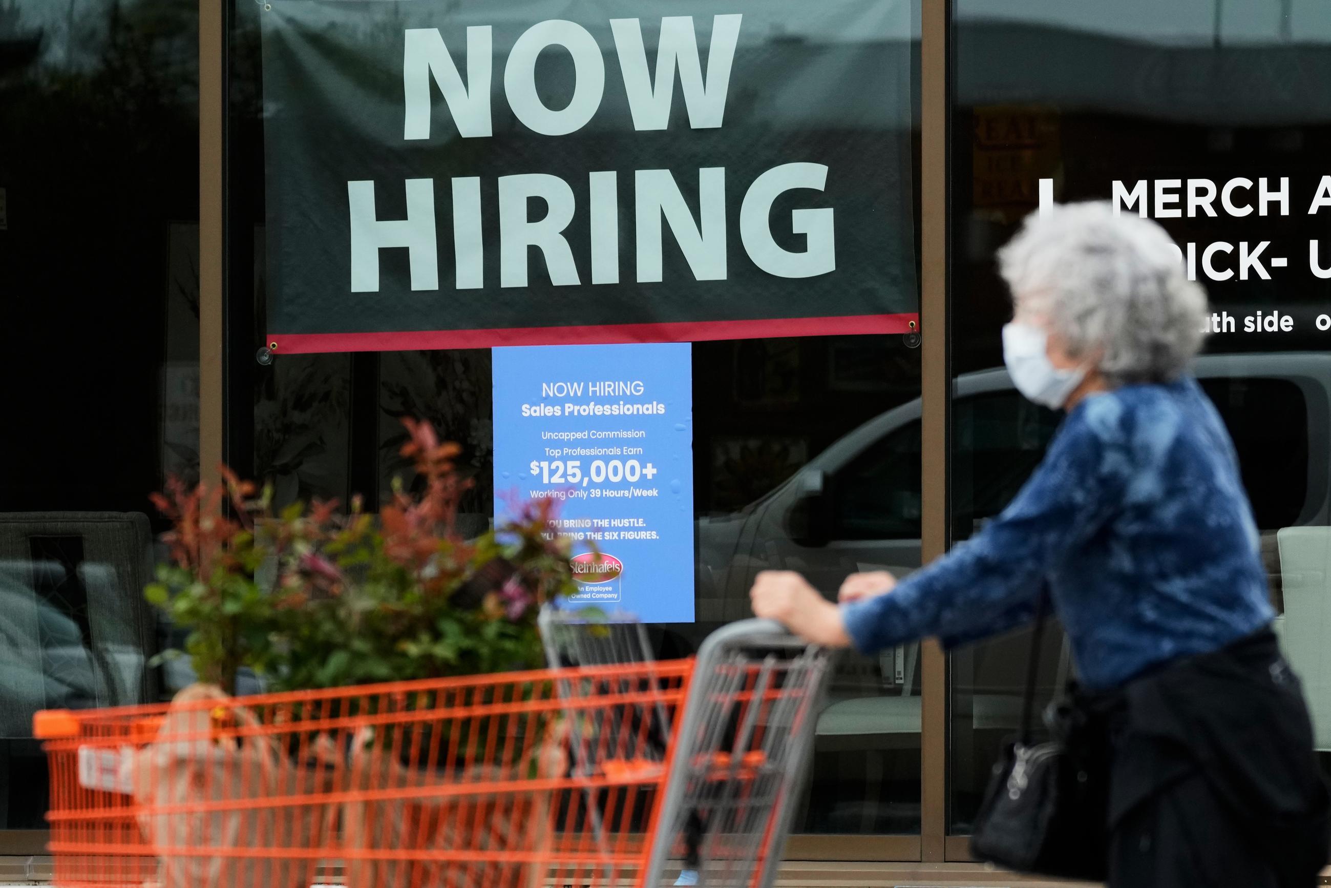 FILE - A hiring sign for sales professionals is displayed at a store in Vernon Hills, Ill., in April. (AP Photo/Nam Y. Huh, file)