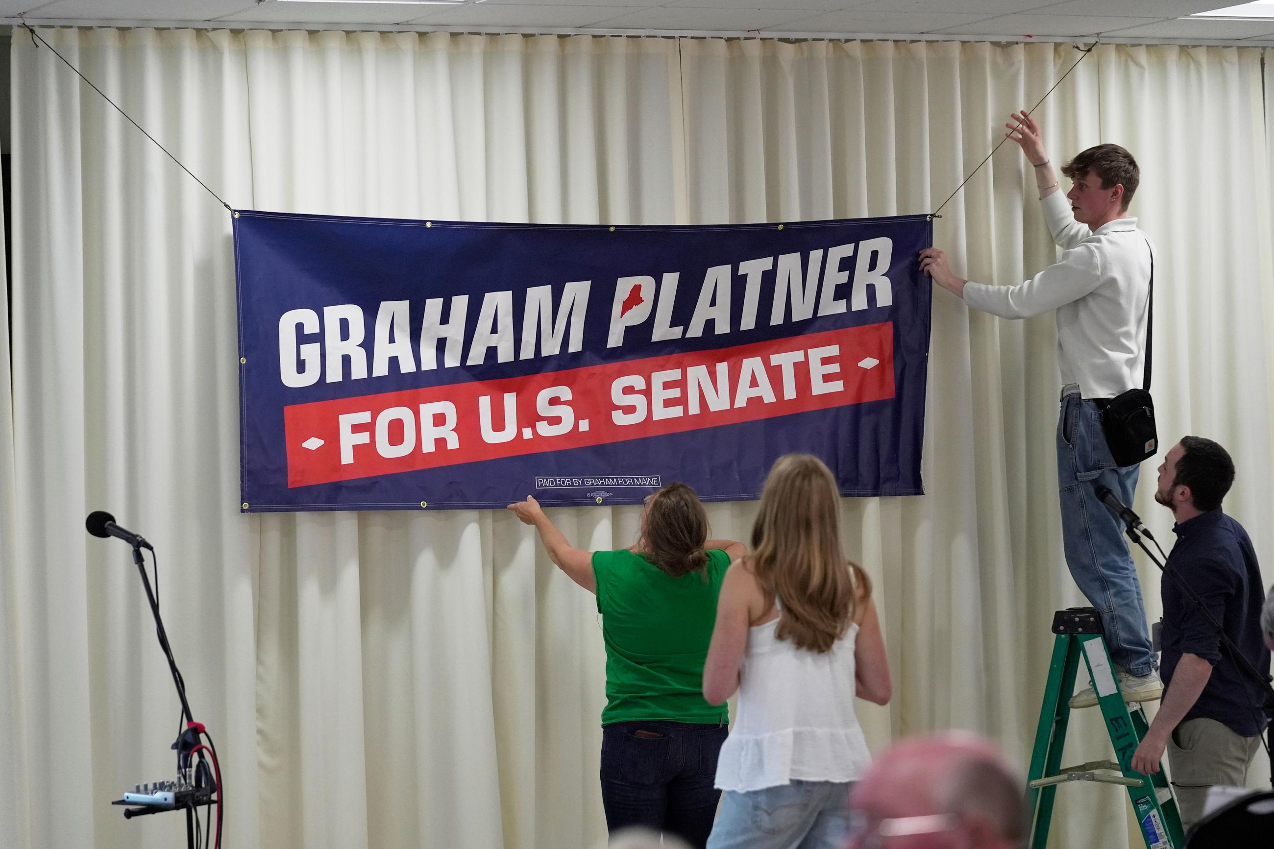 Campaign volunteers prepare a venue before an event hosted by Graham Platner, Democratic candidate for U.S. Senate, Sunday, June 7, 2026, in Portland, Maine. (AP Photo/Robert F. Bukaty)