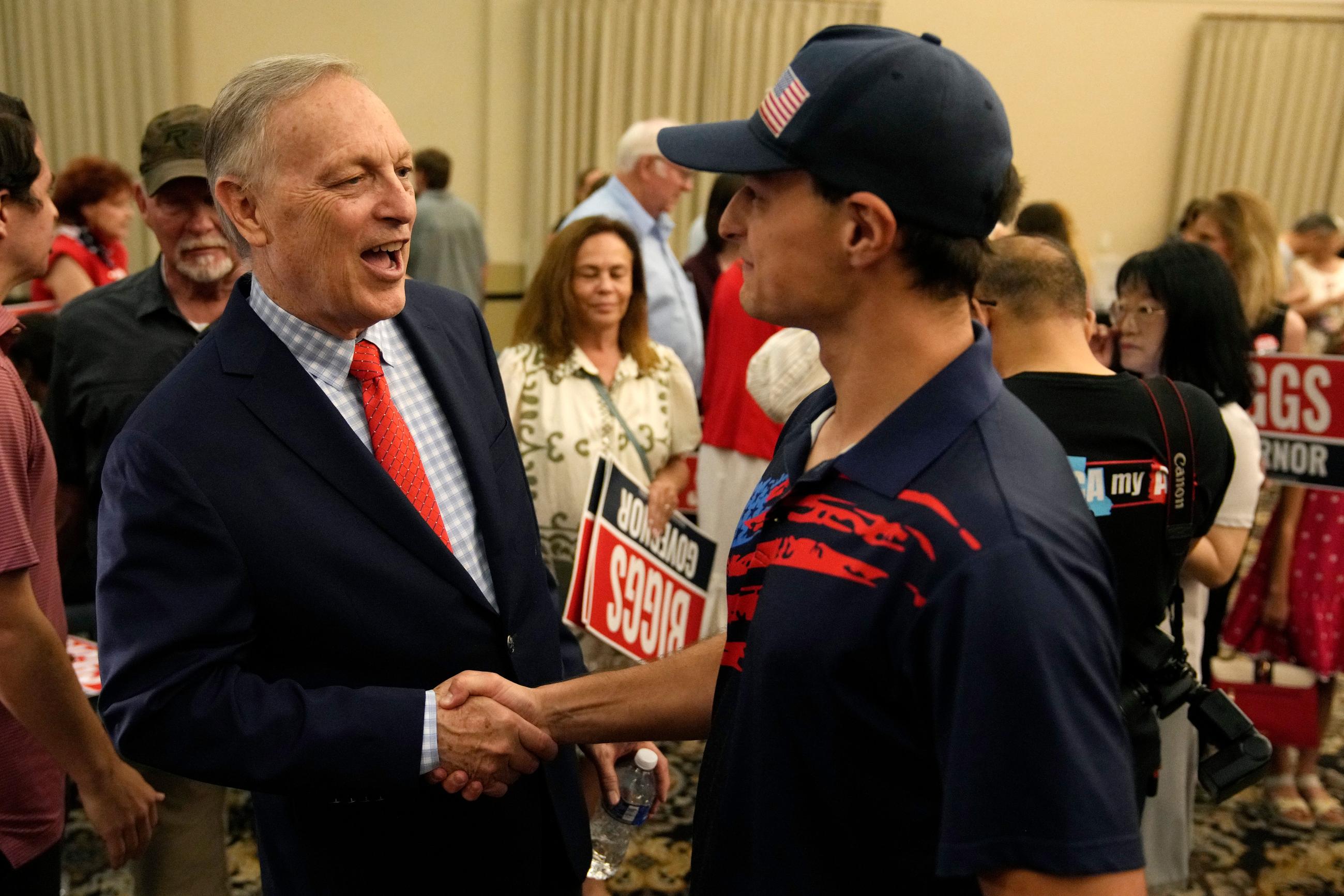 Rep. Andy Biggs, R-Ariz., who is running in the primary for Arizona governor, greets a supporter at a campaign event, Friday, July 17, 2026, in Gilbert, Ariz. (AP Photo/Ross D. Franklin)