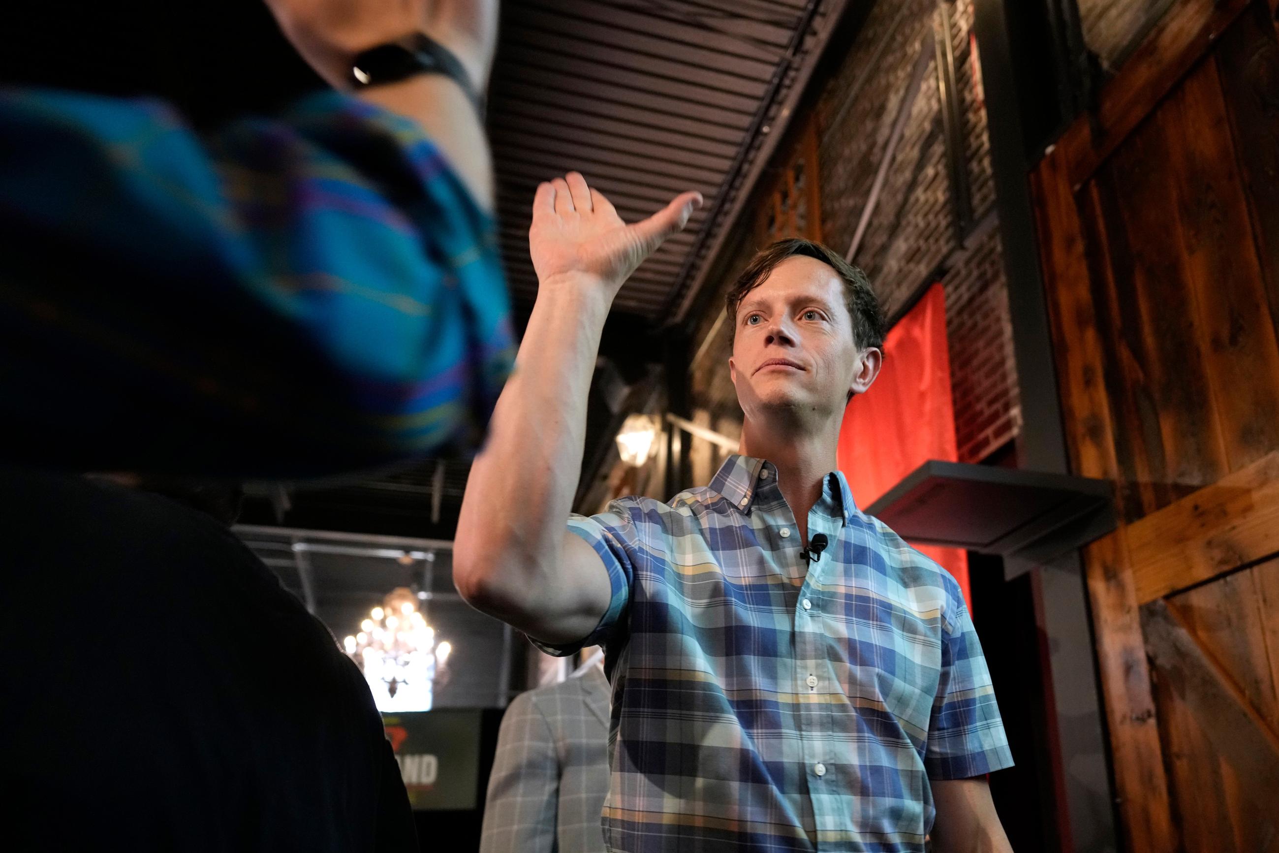 Iowa Democratic gubernatorial candidate Rob Sand greets a supporter during a campaign rally, Sunday, June 7, 2026, in Des Moines, Iowa. (AP Photo/Charlie Neibergall)
