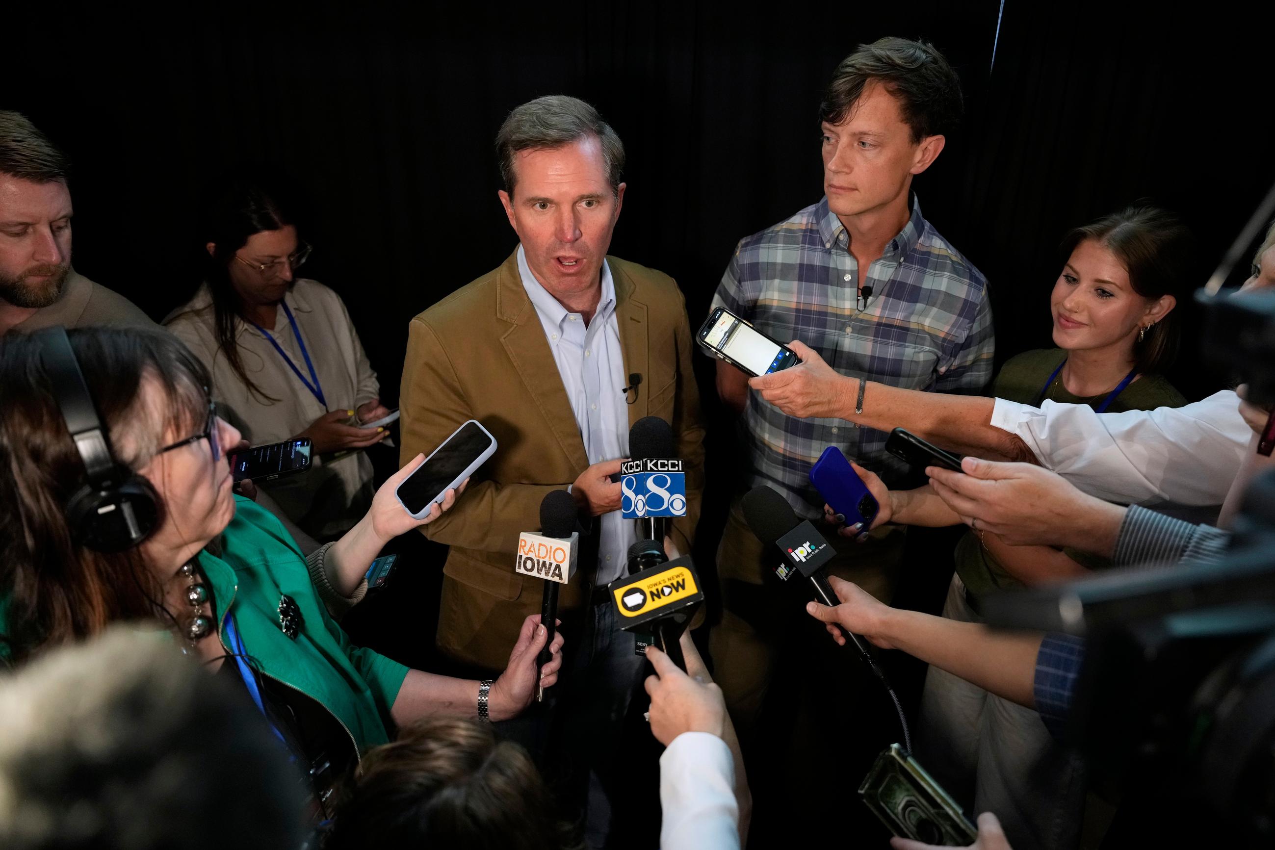 Kentucky Gov. Andy Beshear, left, and Iowa Democratic gubernatorial candidate Rob Sand speak to reporters during a campaign rally, Sunday, June 7, 2026, in Des Moines, Iowa. (AP Photo/Charlie Neibergall)