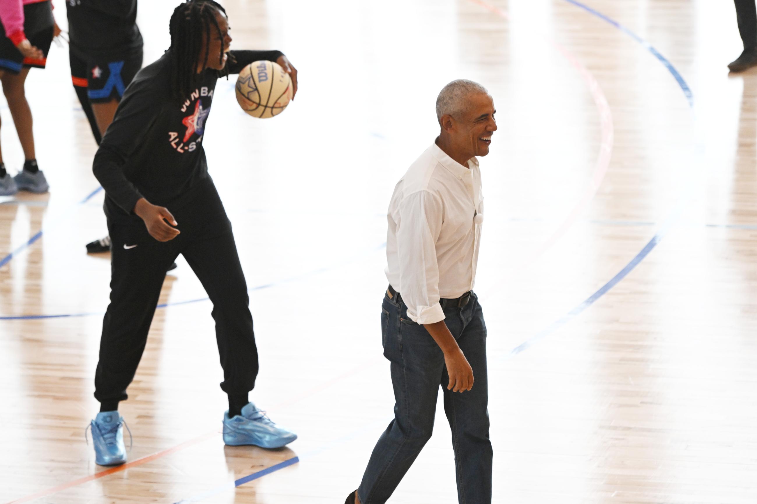 Former President Barack Obama laughs with WNBA All-Star Jonquil Jones after briefly guarding her during a practice at the Obama Presidential Center in Chicago, Friday, July 24, 2026. (AP Photo/Paul Beaty)
