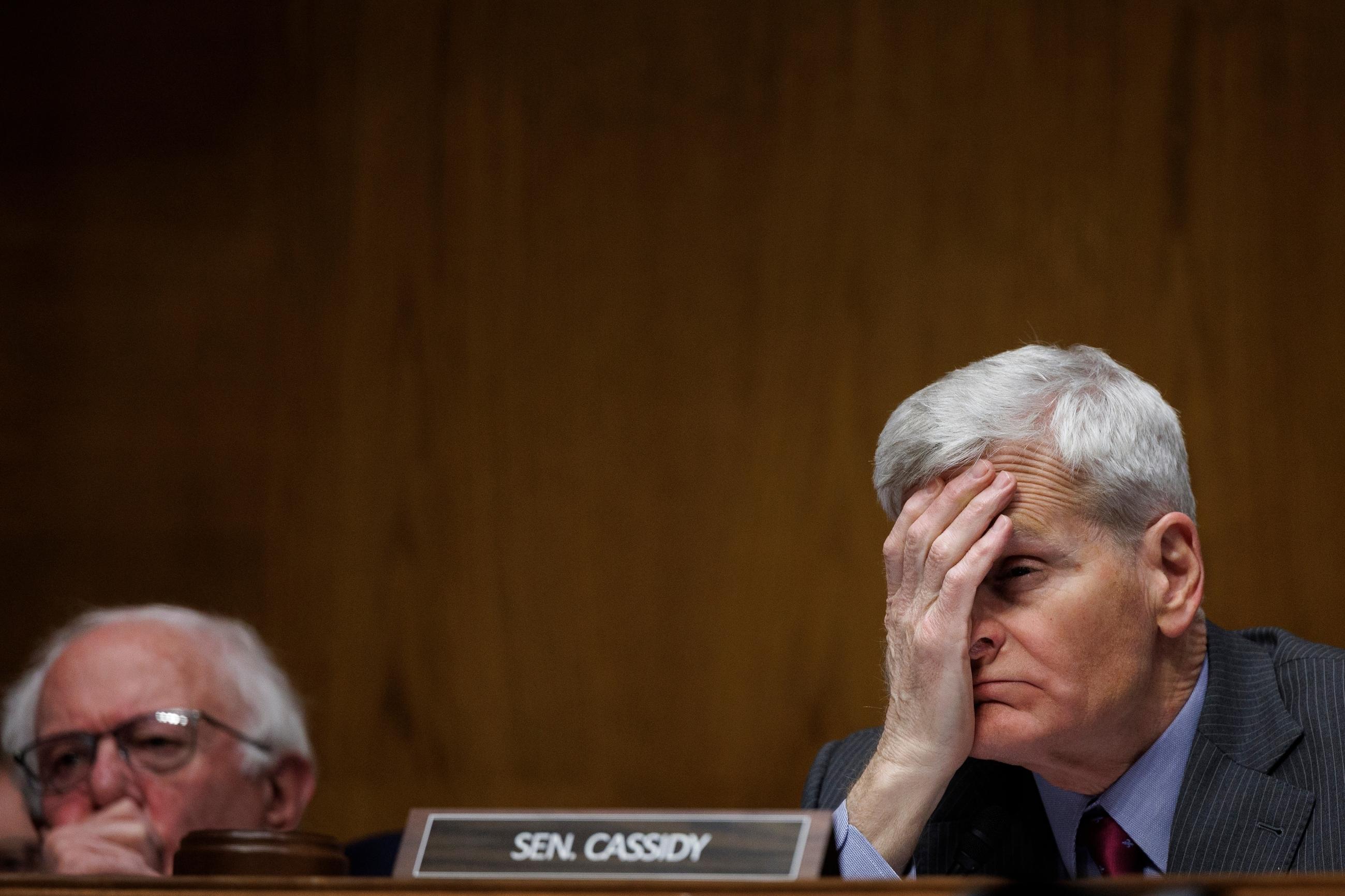 Senate Health, Education, Labor, and Pensions Committee Chair Bill Cassidy holds his head as Casey Means, then the nominee for U.S. surgeon general, testifies during a confirmation hearing on Feb. 25. (AP Photo/Tom Brenner)