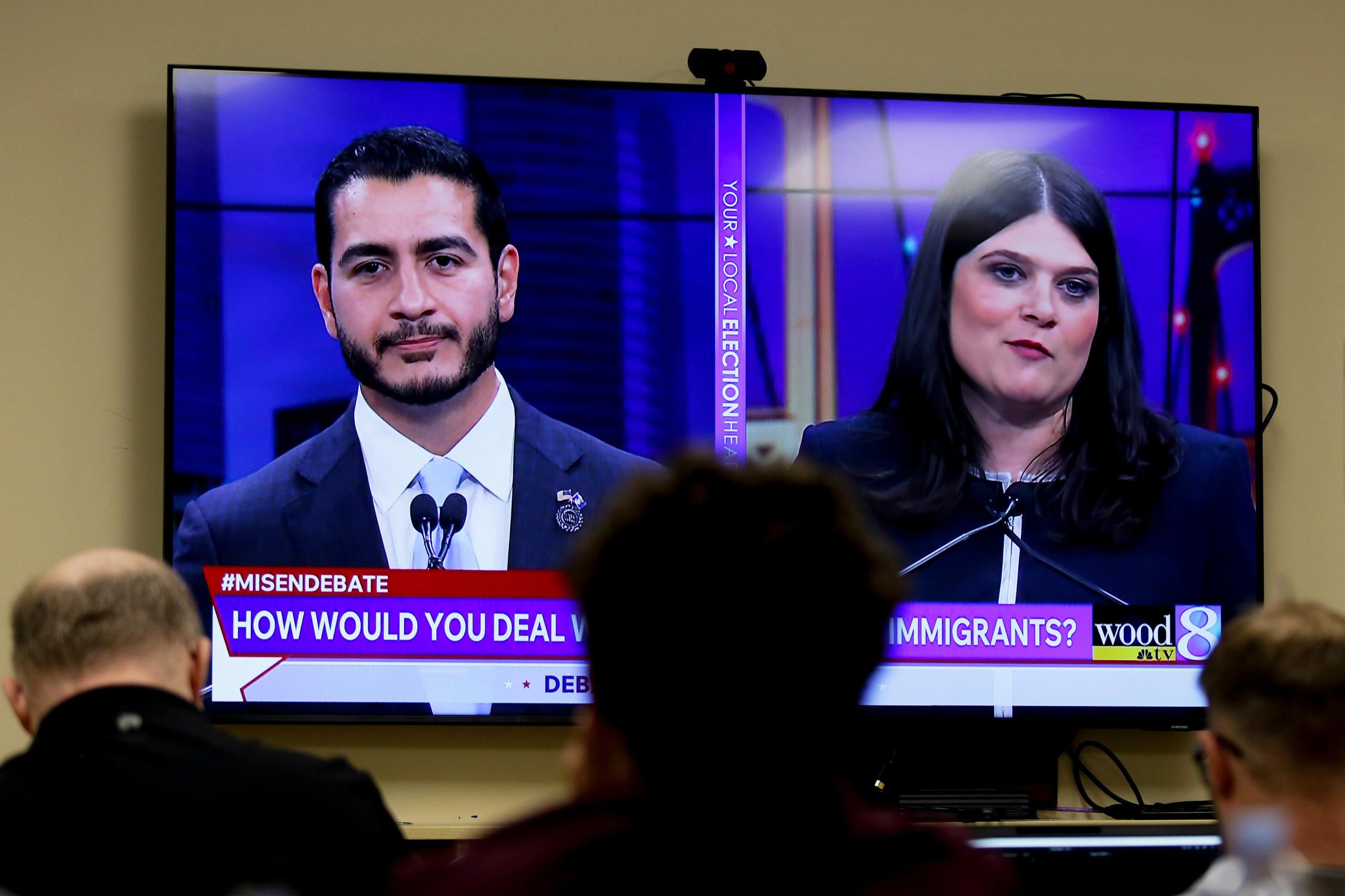 Michigan U.S. Senate candidates, Abdul El-Sayed, left, and Rep. Haley Stevens, D-Mich., are displayed on a television during a debate inside the spin room at WoodTV studios on Tuesday, July 7, 2026, in Grand Rapids, Mich. (AP Photo/Kristen Norman)