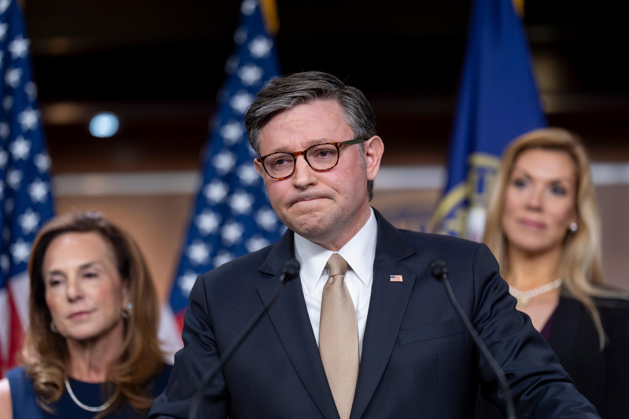 Speaker of the House Mike Johnson, R-La., flanked by Rep. Lisa McClain, R-Mich., chair of the House Republican Conference, left, and Rep. Beth Van Duyne, R-Texas, talks to reporters after a Republican Conference meeting at the Capitol in Washington, Tuesday, June 30, 2026. (AP Photo/J. Scott Applewhite)