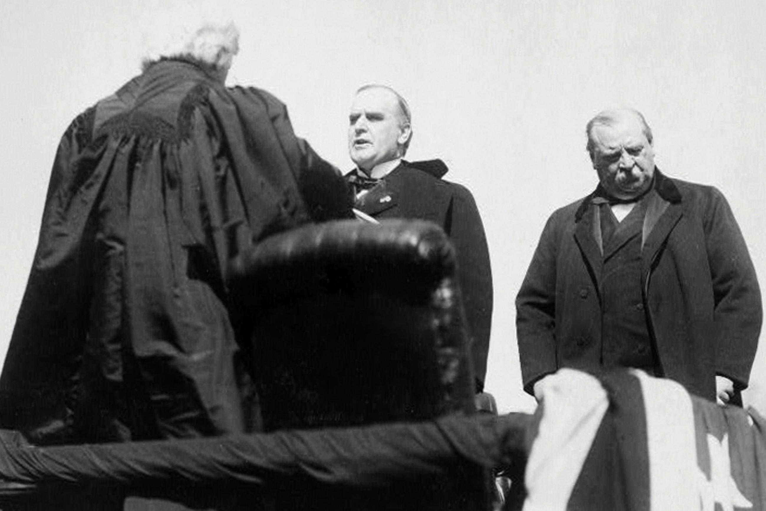 Chief Justice Melville Weston Fuller, from left, administers the oath of office to Major William McKinley during his presidential inauguration in Washington, 1897 circa, as outgoing President Grover Cleveland looks. (Library of Congress via AP)