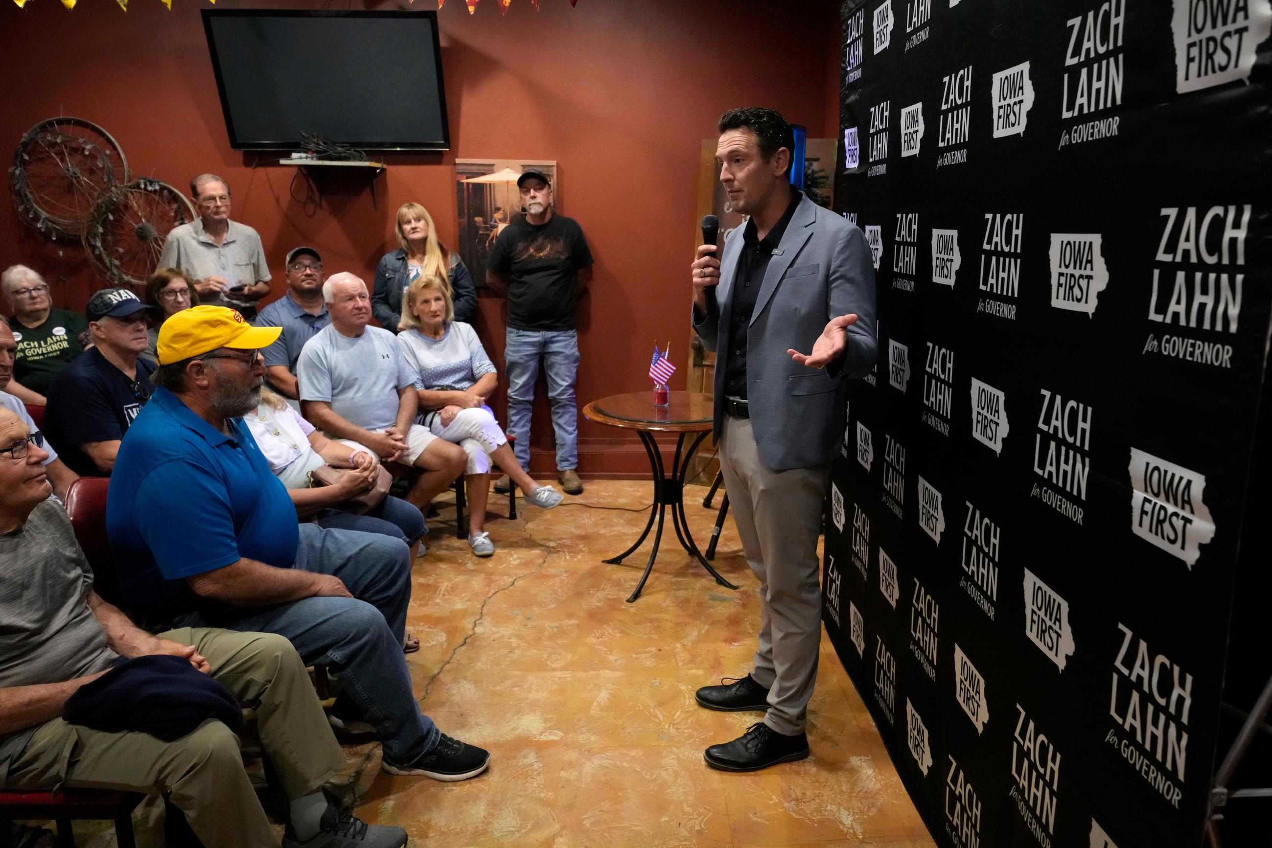 Zach Lahn, Republican candidate for Iowa governor, speaks to local residents during a meet and greet, Tuesday, Aug. 4, 2026, in Hampton, Iowa. (AP Photo/Charlie Neibergall)