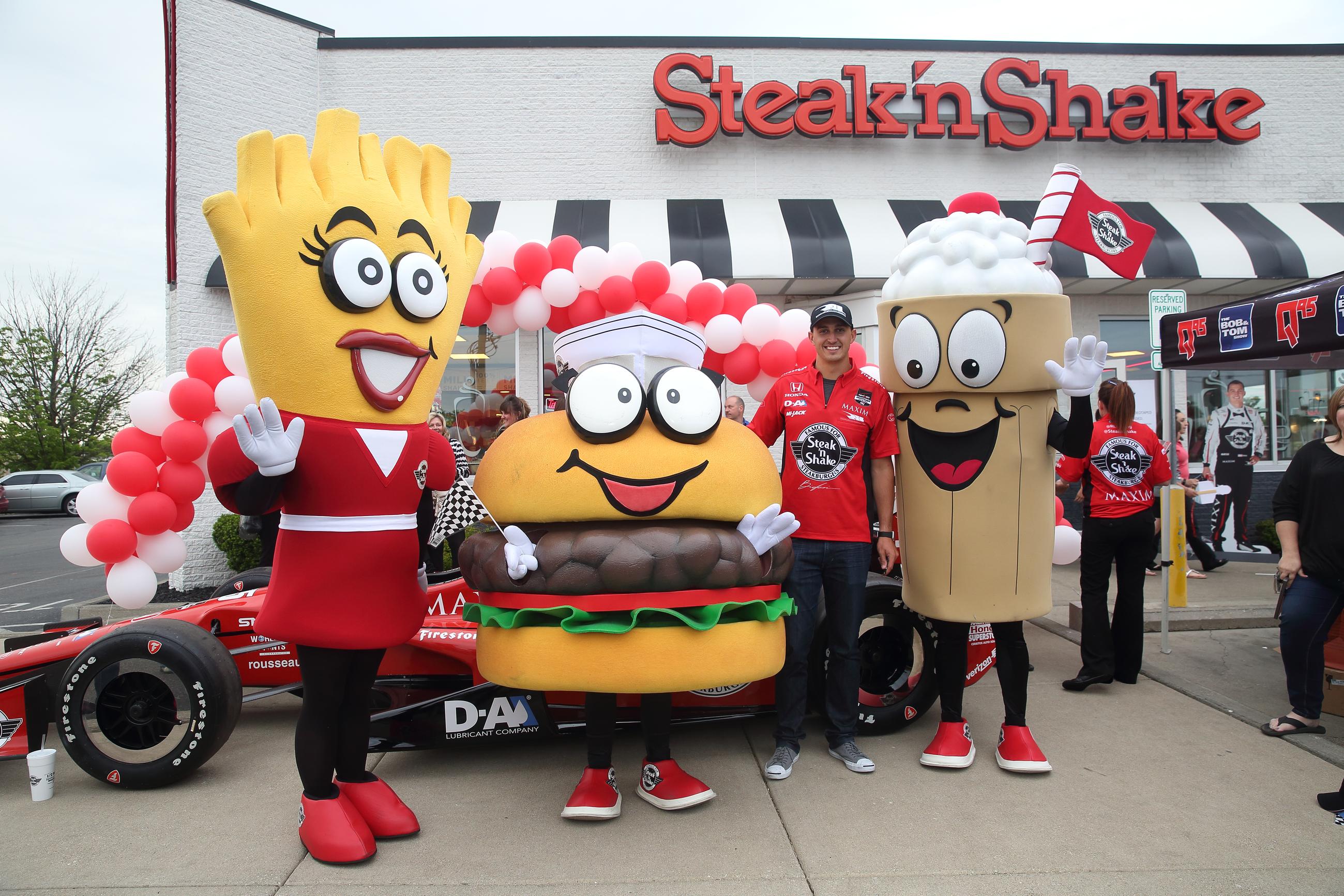 The No. 15 Steak ‘n Shake Indy car driver Graham Rahal poses with Steak ‘n Shake mascots Goldie, Sizzle and Shaker on Thursday, May 14, 2015, in Indianapolis, Indiana. (Photo by Steve C. Mitchell/Invision for Steak n' Shake/AP Images)