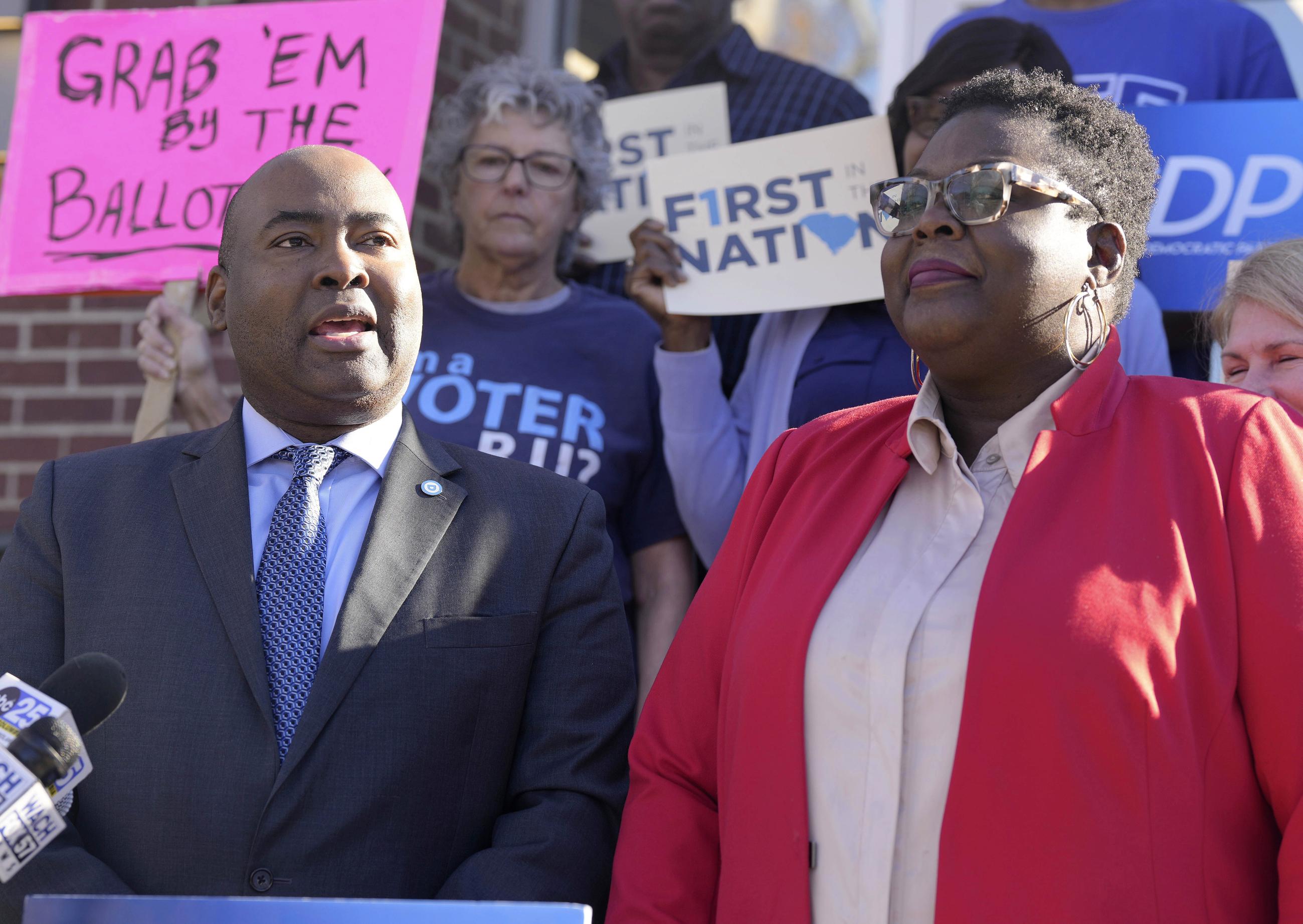 Democratic National Committee Chairman Jaime Harrison, left, stands with with South Carolina Democratic Party Chair Christale Spain as they take questions from reporters following an announcement about get out the vote efforts ahead of South Carolina's first-in-the-nation Democratic presidential primary on Monday, Dec. 11, 2023, in Columbia, S.C. (AP Photo/Meg Kinnard)