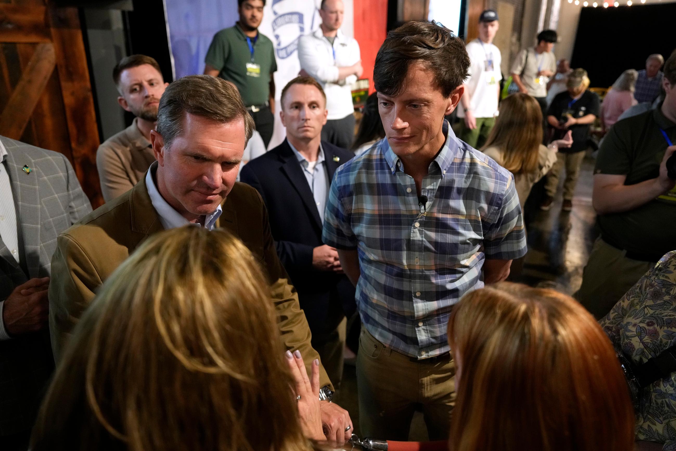 Kentucky Gov. Andy Beshear and Iowa Democratic gubernatorial candidate Rob Sand speak to supporters during a campaign rally in Des Moines on June 7. (AP Photo/Charlie Neibergall)