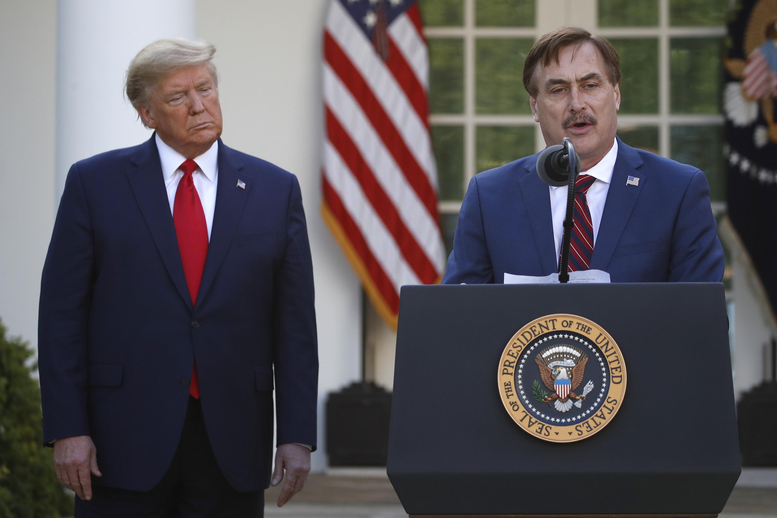 My Pillow CEO Mike Lindell speaks as President Trump listens during a March 2020 briefing about COVID in the Rose Garden. (AP Photo/Alex Brandon)