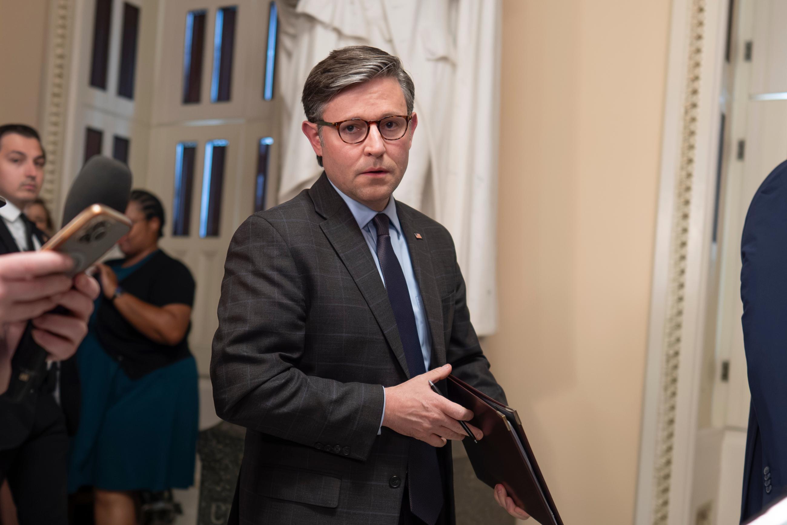 House Speaker Mike Johnson talks to reporters on Tuesday just after the House passed a short-term measure to fund the federal government into early December. (AP Photo/J. Scott Applewhite)