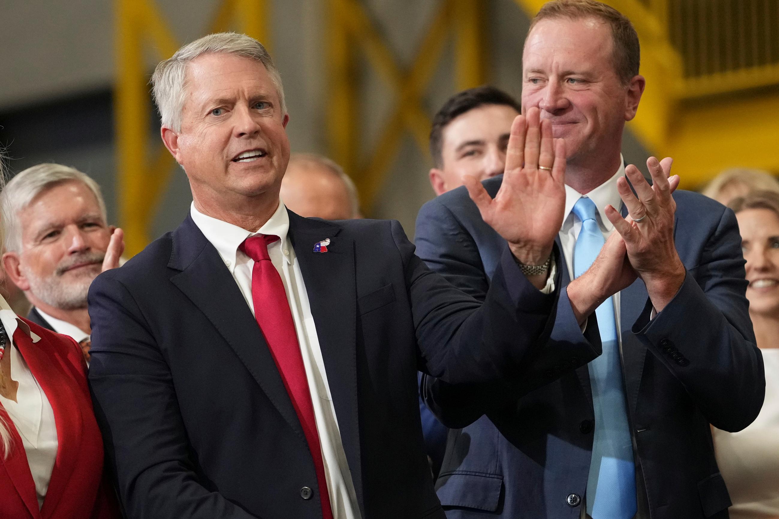 Sen. Roger Marshall of Kansas waves as Sen. Eric Schmitt of Missouri looks on during an event with Vice President J.D. Vance in Olathe, Kan., on Monday. (AP Photo/Mark Schiefelbein, Pool)