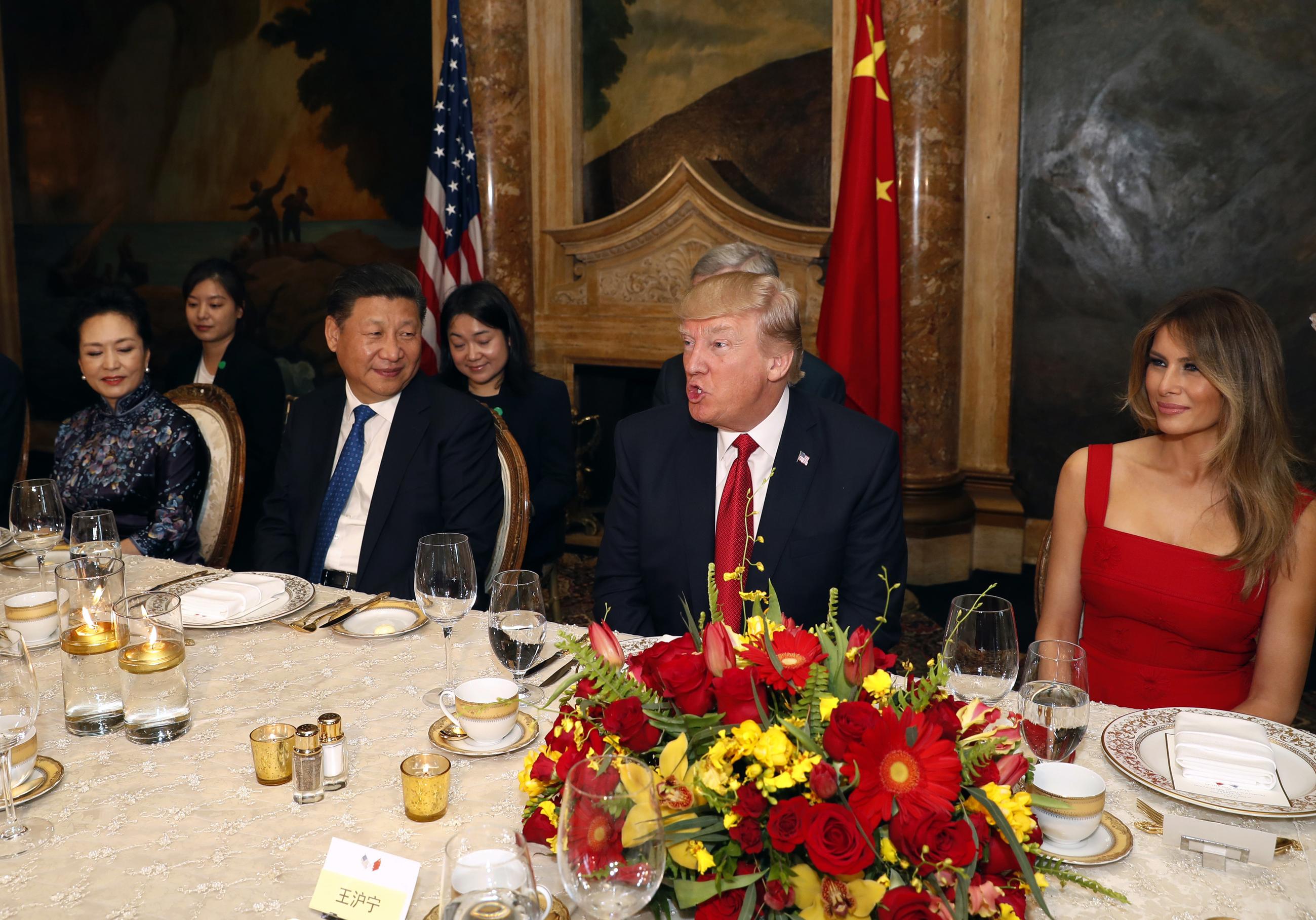 In this 2017 file photo, Trump and Xi, with first lady Melania Trump and Chinese first lady Peng Liyuan, are seated during a dinner at Mar-a-Lago, during which Trump promised Xi the most beautiful chocolate cake he'd ever seen. (AP Photo/Alex Brandon, File)