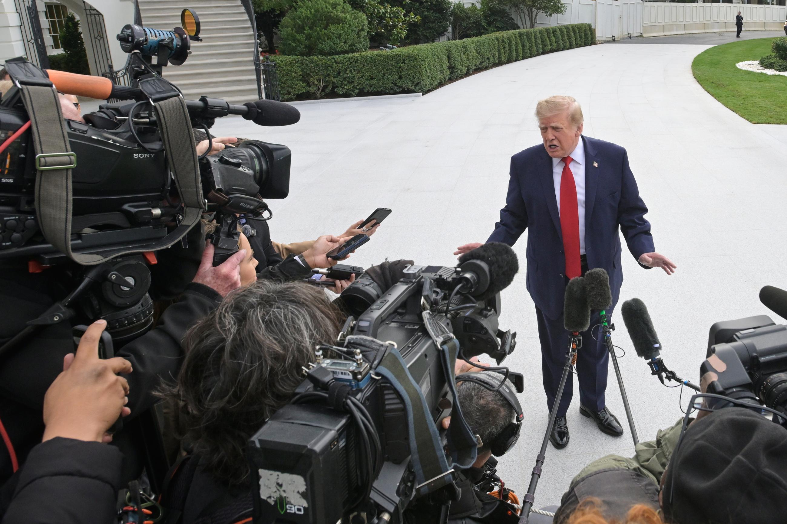 President Donald Trump talks with reporters on the South Lawn of the White House before boarding Marine One, Saturday, Sept. 26, 2026, in Washington. (AP Photo/Rod Lamkey, Jr.)