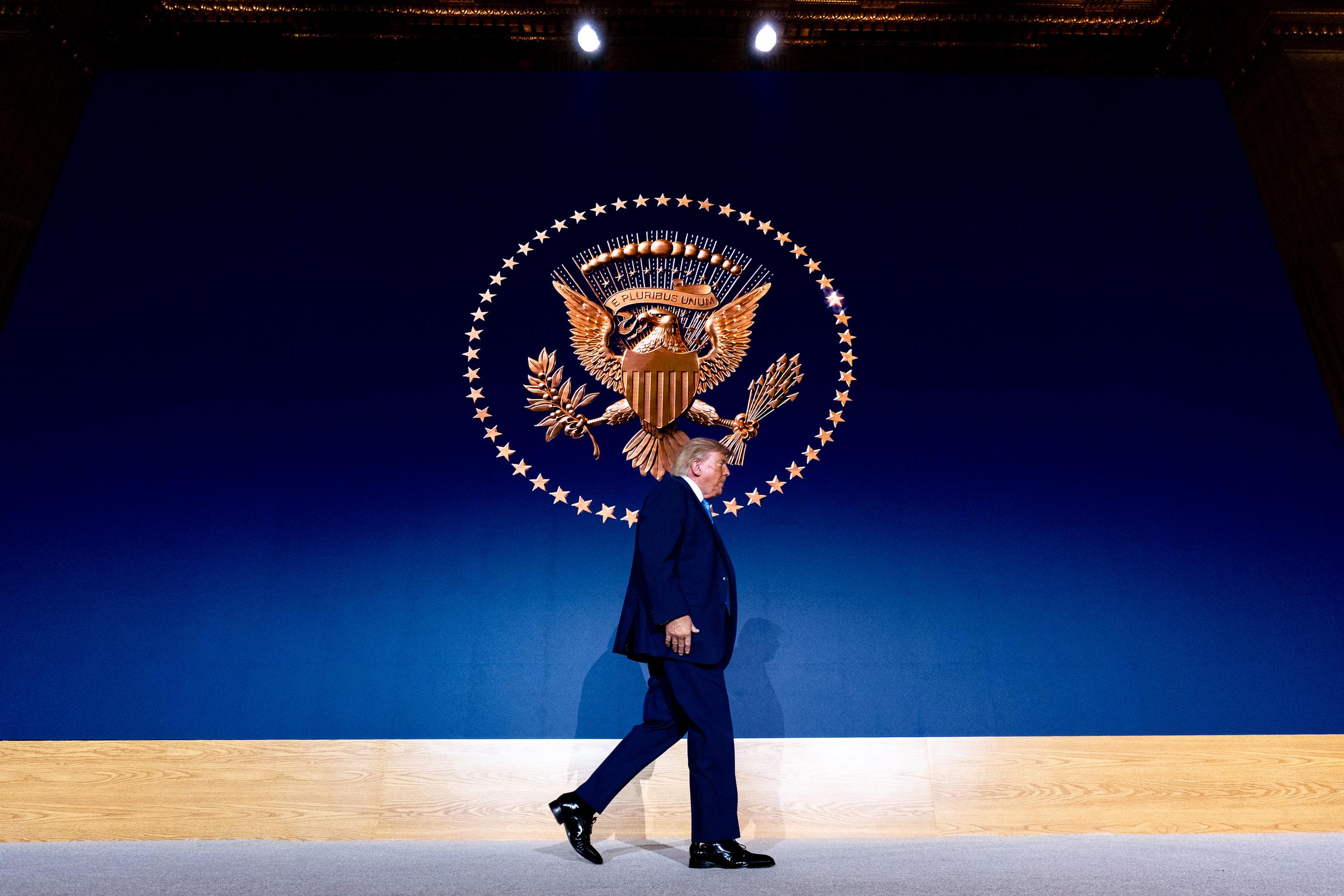 President Donald Trump walks across the stage under the Presidential Seal at the Andrew W. Mellon Auditorium, Tuesday, Sept. 29, 2026, in Washington. (AP Photo/Alex Brandon)