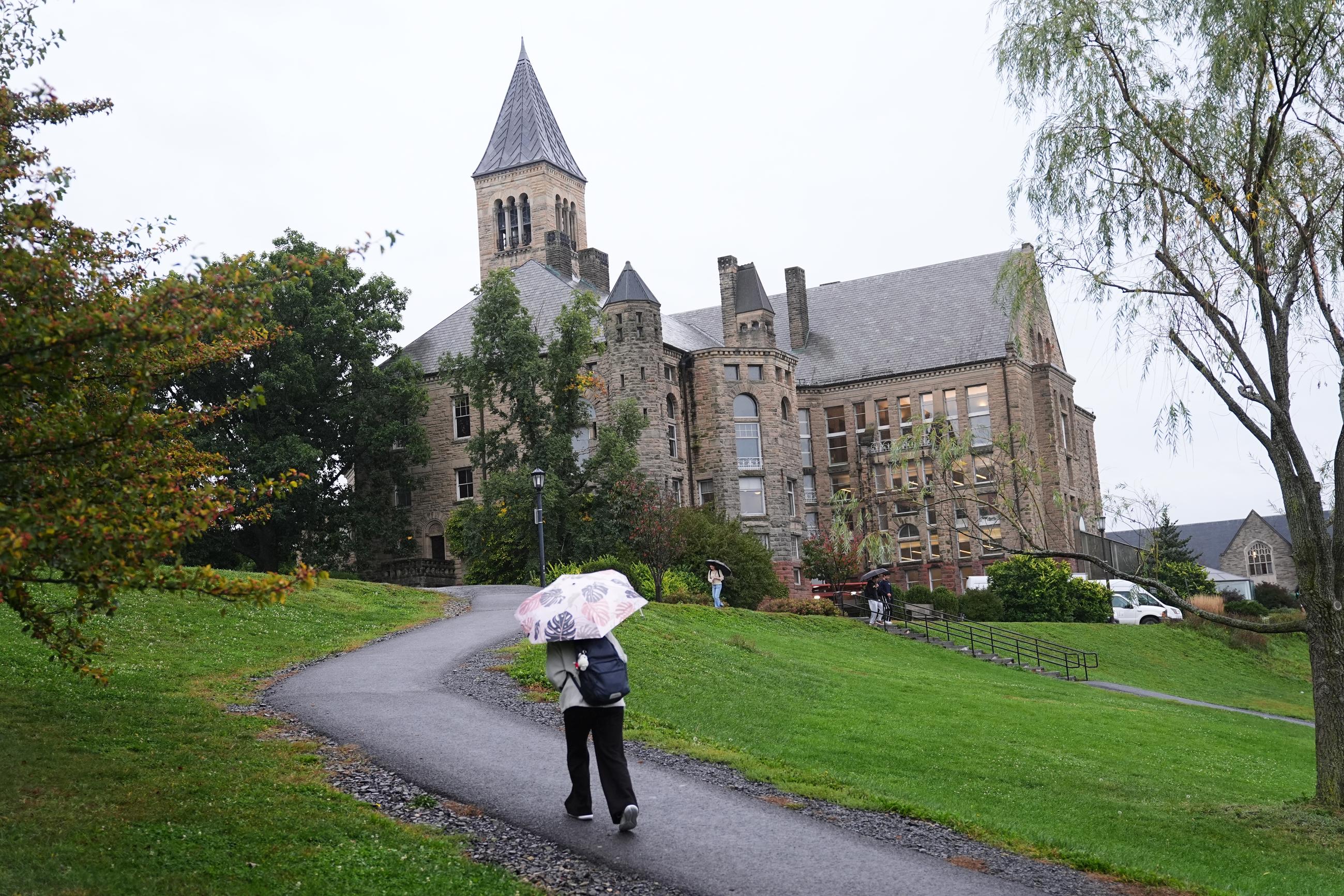 Students walk across the campus of Cornell University in Ithaca, N.Y., on Thursday. (AP Photo/Matt Rourke)