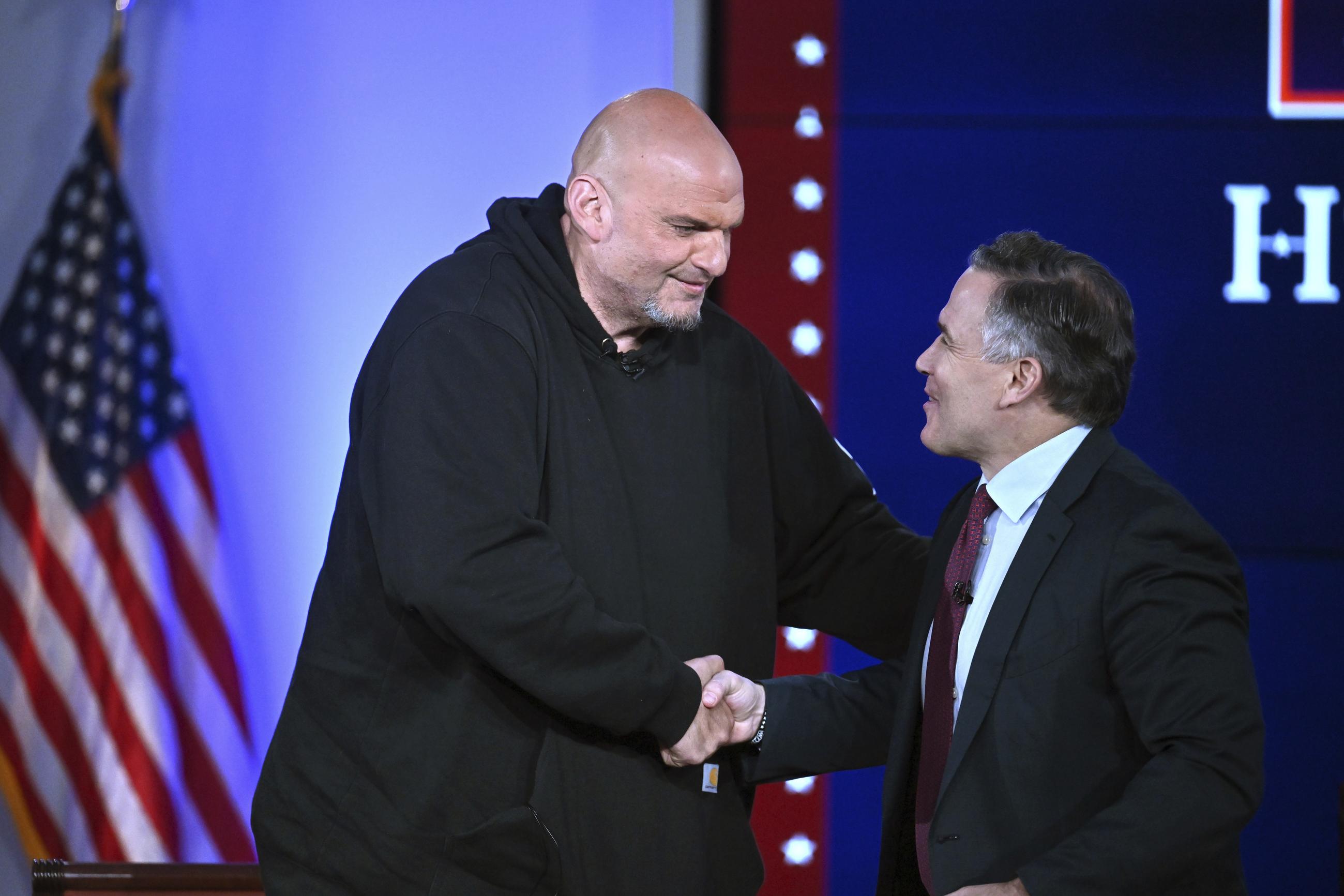 Democratic Sen. John Fetterman and Republican Sen. Dave McCormick, both of Pennsylvania, at an event in 2025 (AP Photo/Steven Senne)