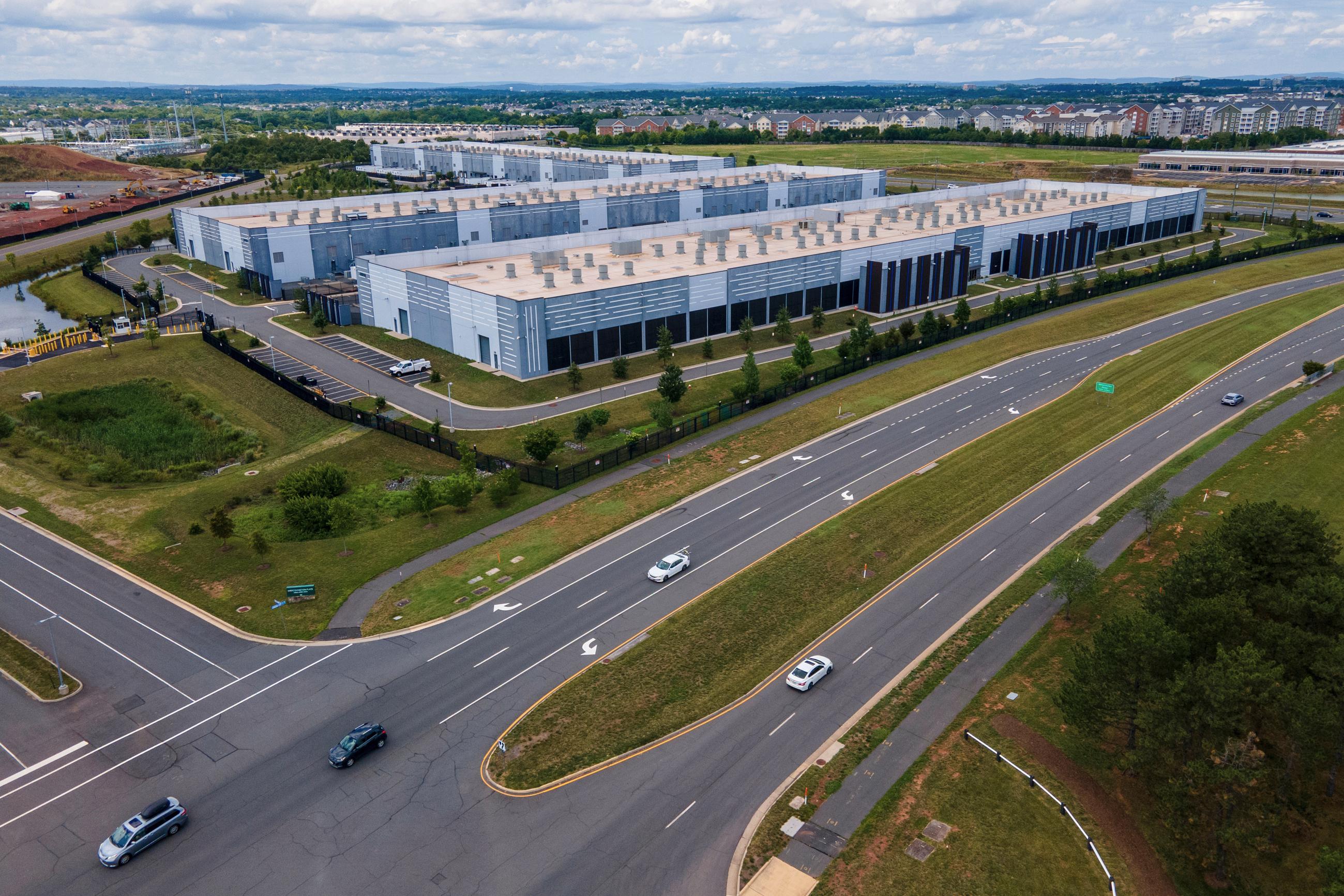 FILE - Cars drive past data centers in Ashburn, Va., in 2023. (AP Photo/Ted Shaffrey, File)