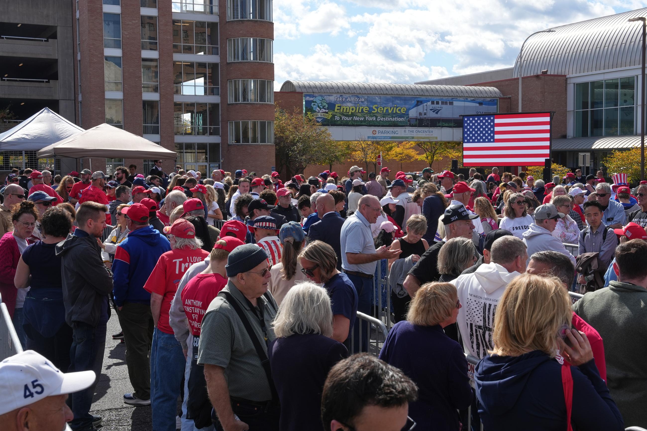 People wait in line before President Trump attends a campaign rally in Syracuse, N.Y., on Friday. (AP Photo/Matt Burkhartt)