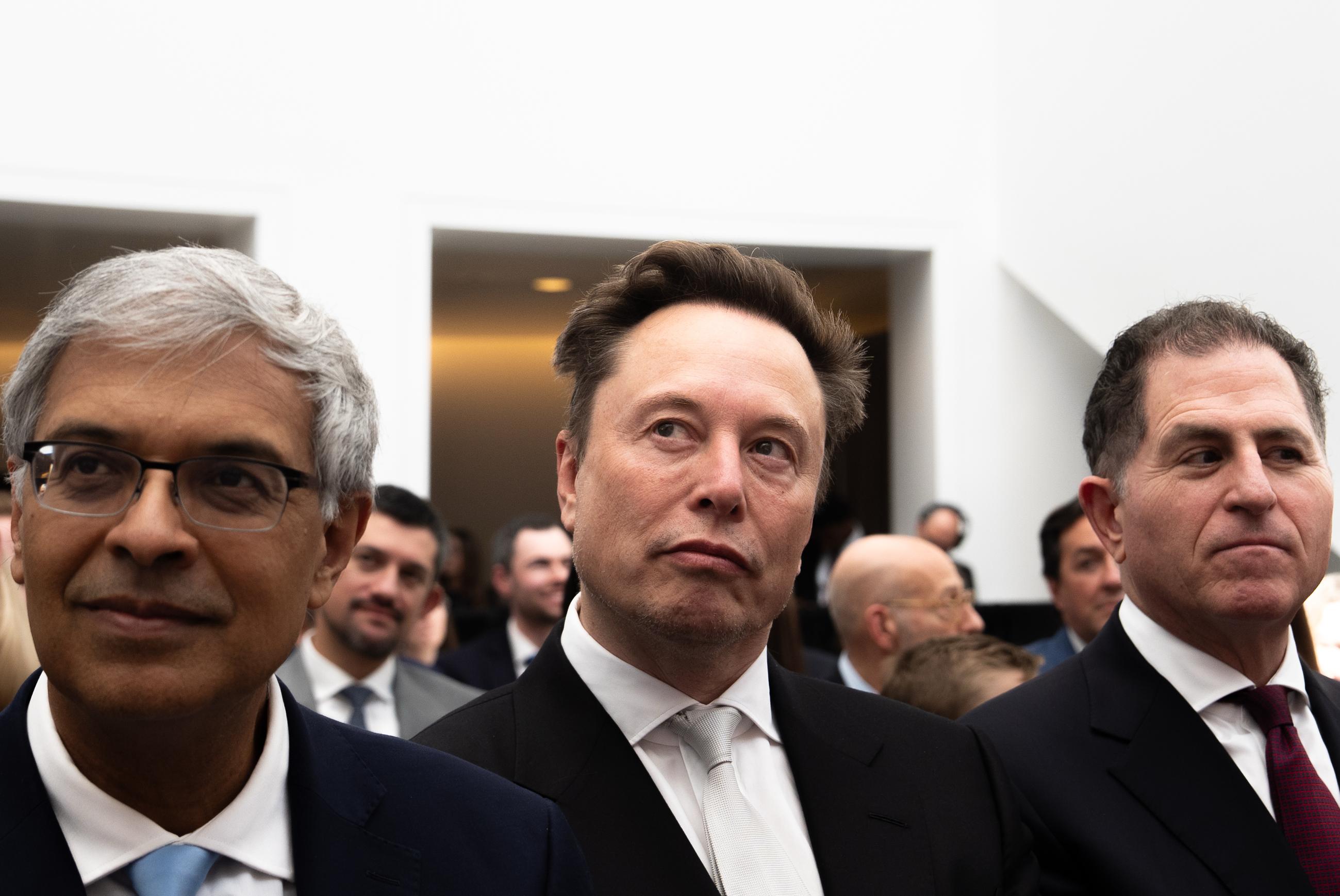 Jay Bhattacharya, director of the National Institutes of Health, from left, Elon Musk and Dell CEO Michael Dell listen to President Donald Trump speak at the U.S. Institute of Peace, Thursday, Oct. 8, 2026, in Washington. (AP Photo/Julia Demaree Nikhinson)