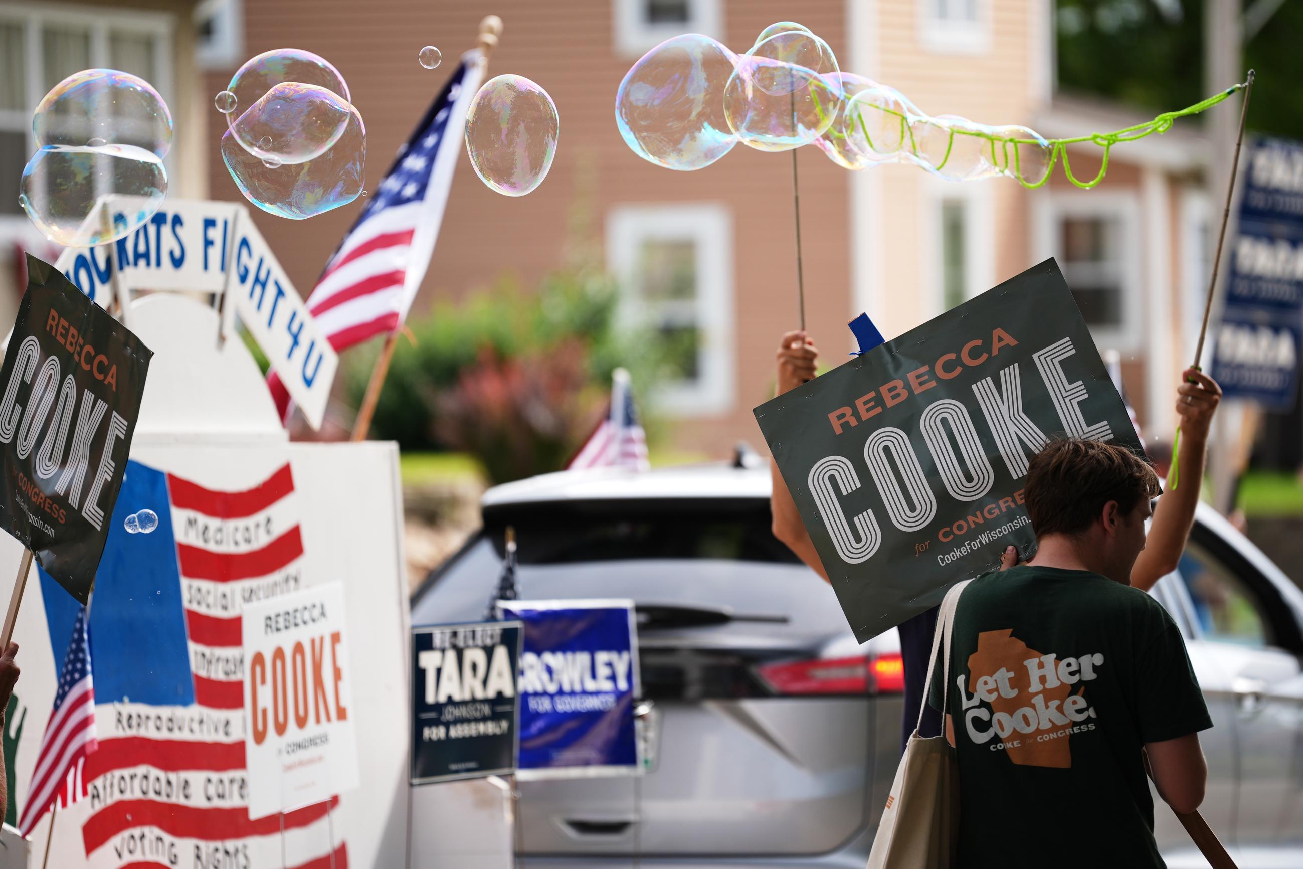 Supporters of Rebecca Cooke, Democratic candidate for Wisconsin's 3rd Congressional District, march in a Labor Day parade in Readstown, Wis., on Sept. 7. (AP Photo/Ellen Schmidt)