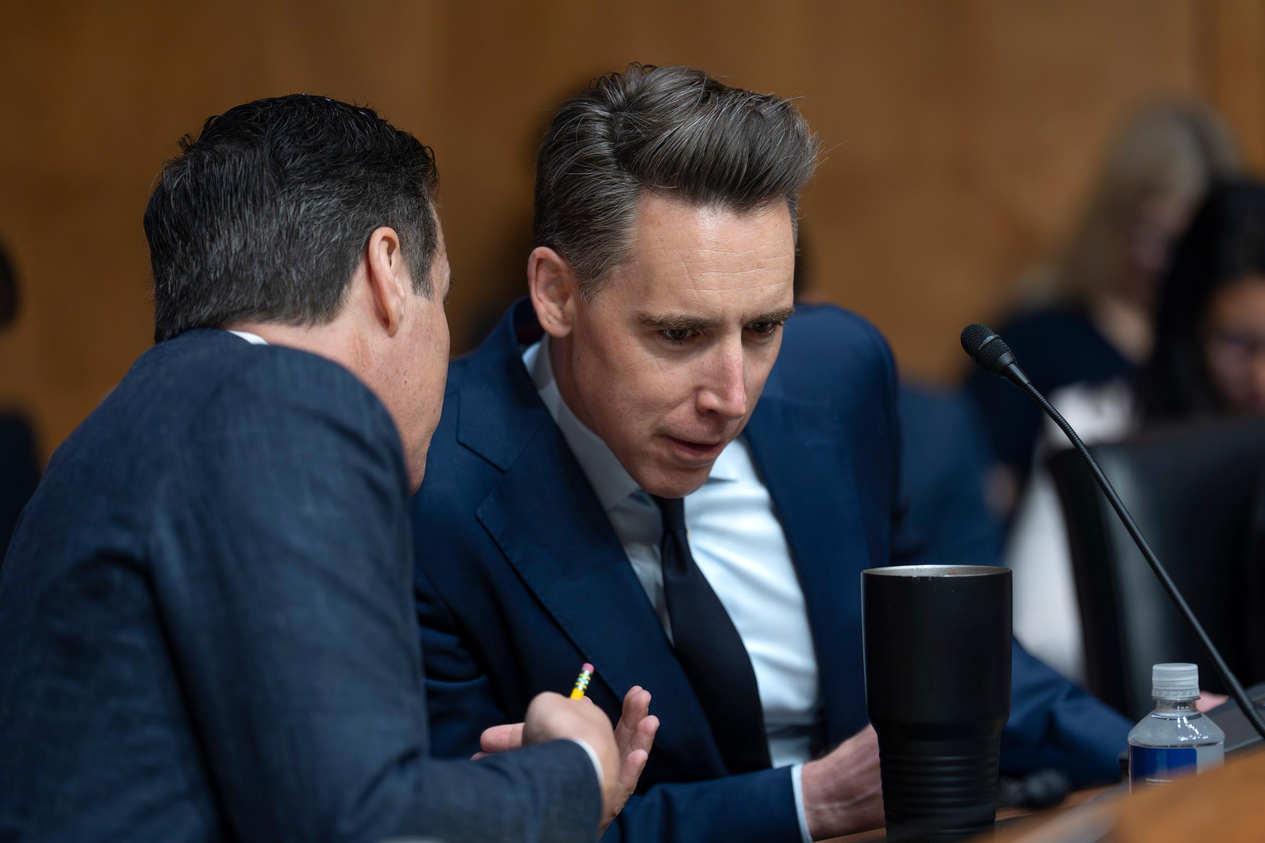 Sen. Josh Hawley (center) confers with Sen. Bernie Moreno at a Senate Homeland Security Committee markup in May. (AP Photo/J. Scott Applewhite)