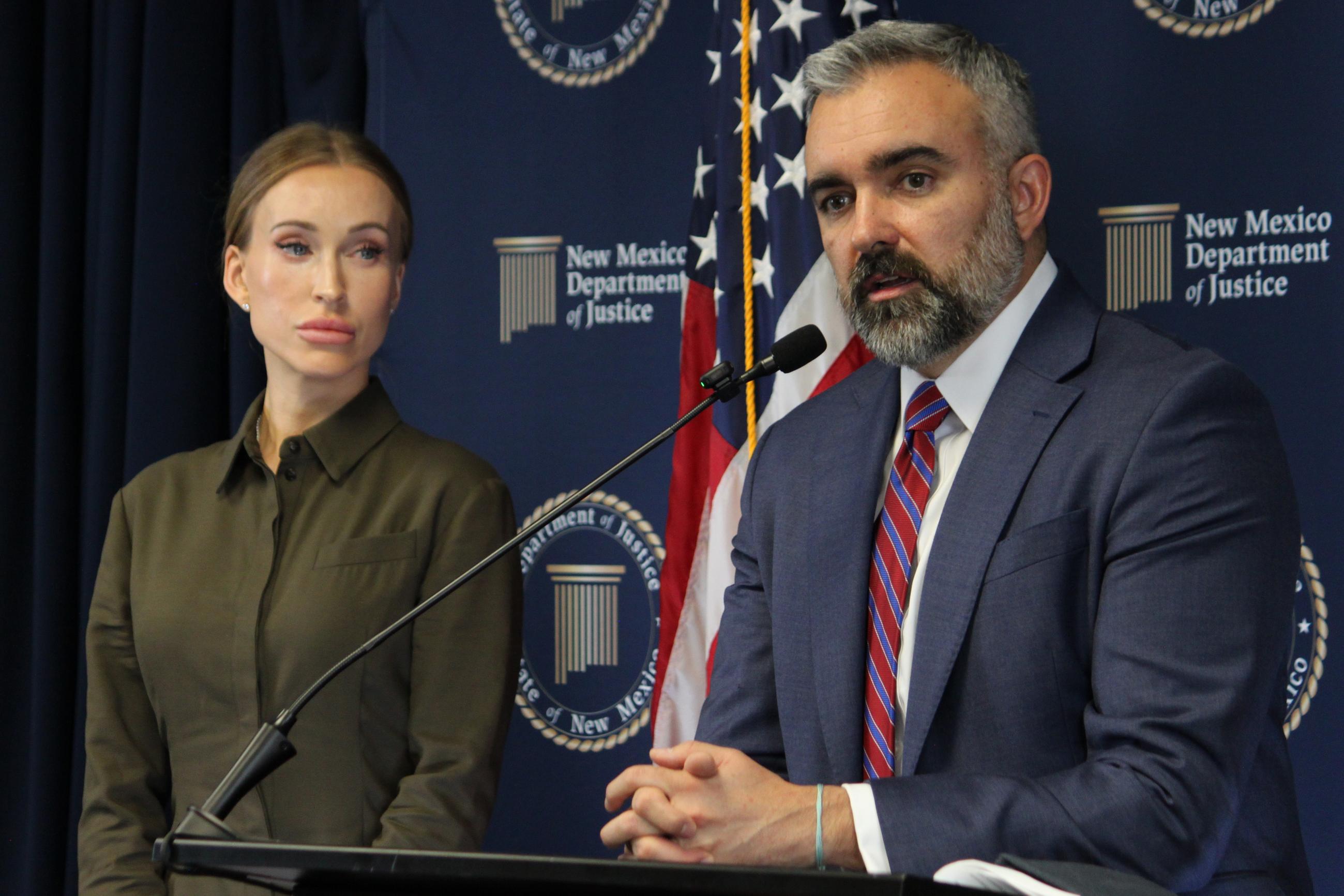 New Mexico Attorney General Raúl Torrez stands with Julia Molchanova (left) as he answers questions about a lawsuit against the co-executors of Jeffrey Epstein's estate during a news conference in Albuquerque, N.M., on Wednesday. (AP Photo/Susan Montoya Bryan)