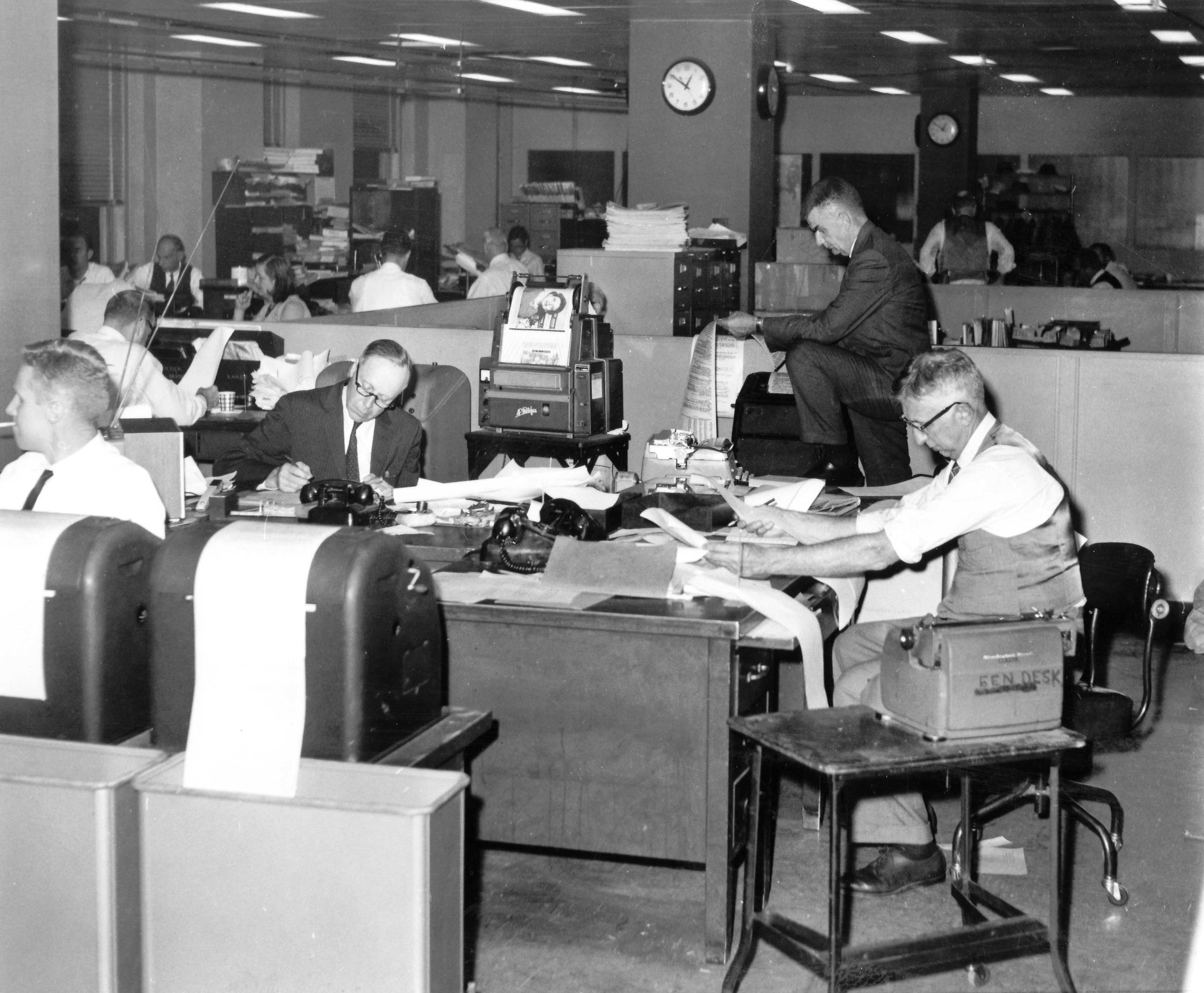AP news executives studying election news reports in the main newsroom in Rockefeller Center, New York City, ca. 1964. (AP Photo/Corporate Archives)