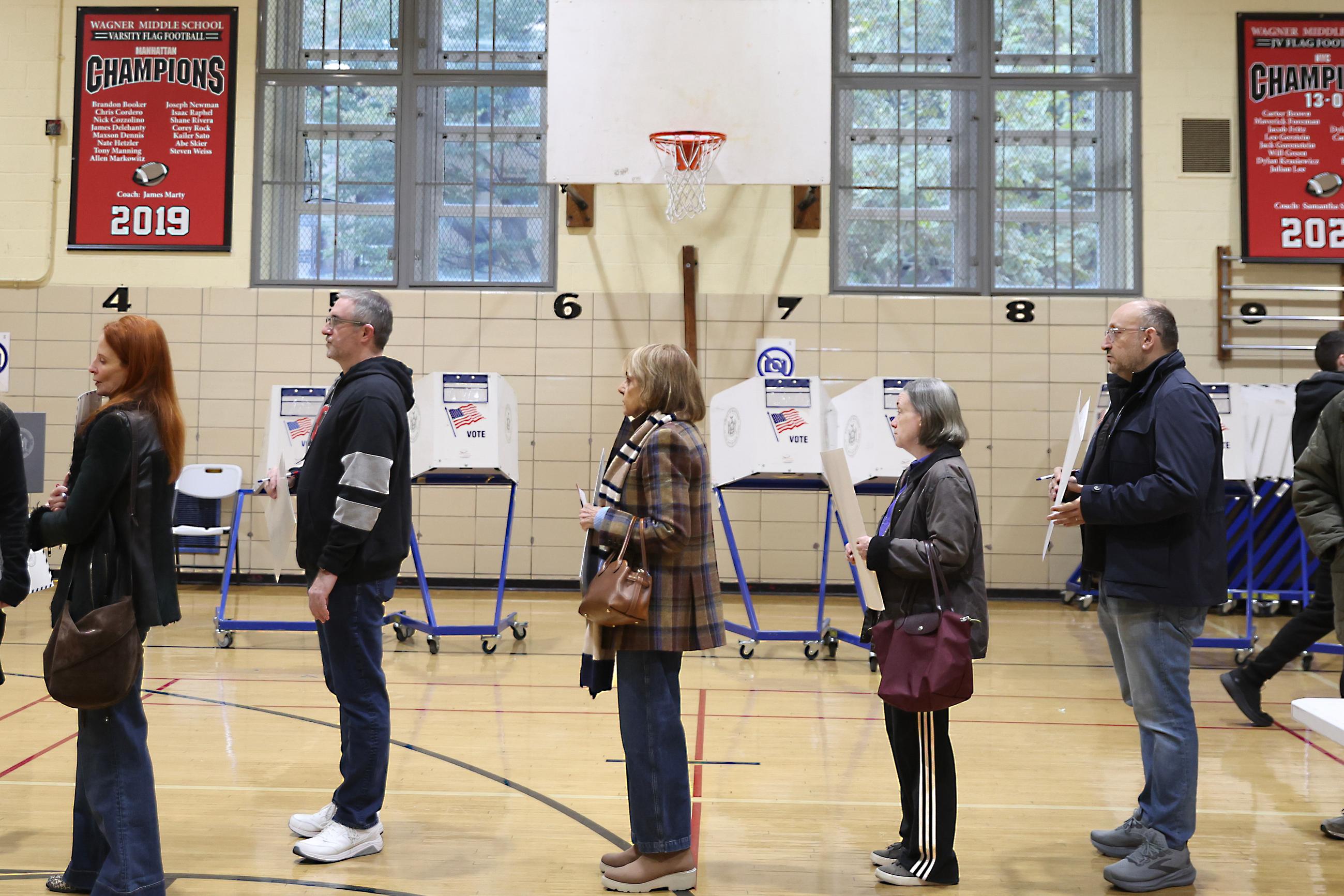 People wait in line to cast their votes on the first day of early voting, Saturday, Oct. 24, 2026, in New York. (AP Photo/Heather Khalifa)